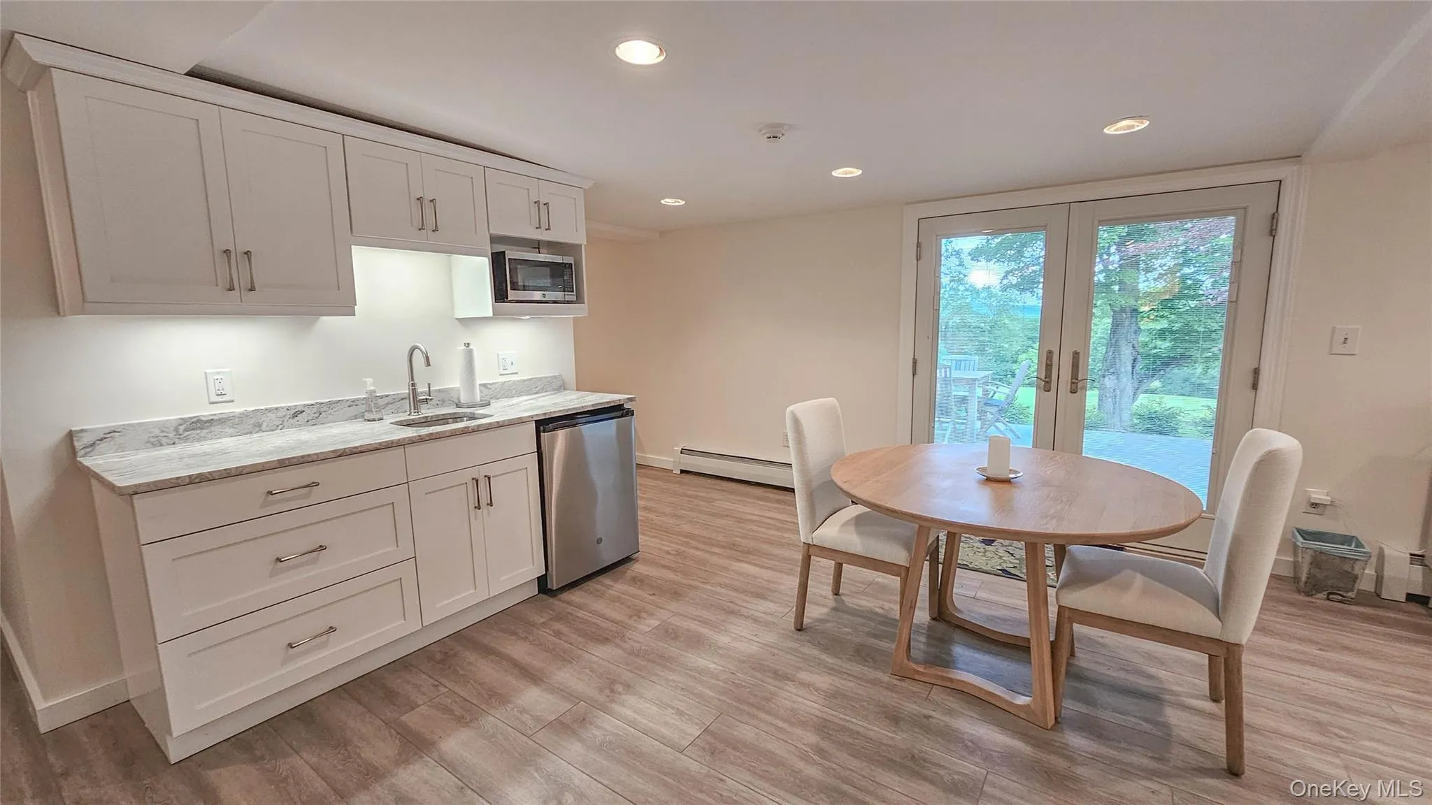 New Kitchenette with granite counter top, new cabinets, under counter lighting, refrigerator, microwave, and sink. New Kitchenette with granite counter top, new cabinets, under counter lighting, refrigerator, microwave, and sink.