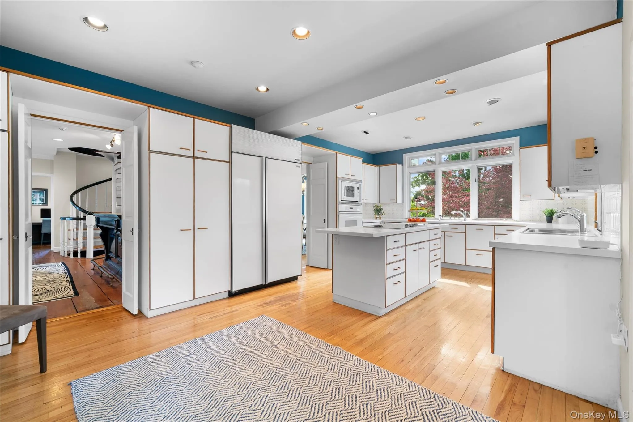 Spacious kitchen featuring Sub Zero refrigerator, new four burner electric cooking top in center island, two dishwashers, built-in microwave and wall oven. Spacious kitchen featuring Sub Zero refrigerator, new four burner electric cooking top in center island, two dishwashers, built-in microwave and wall oven.