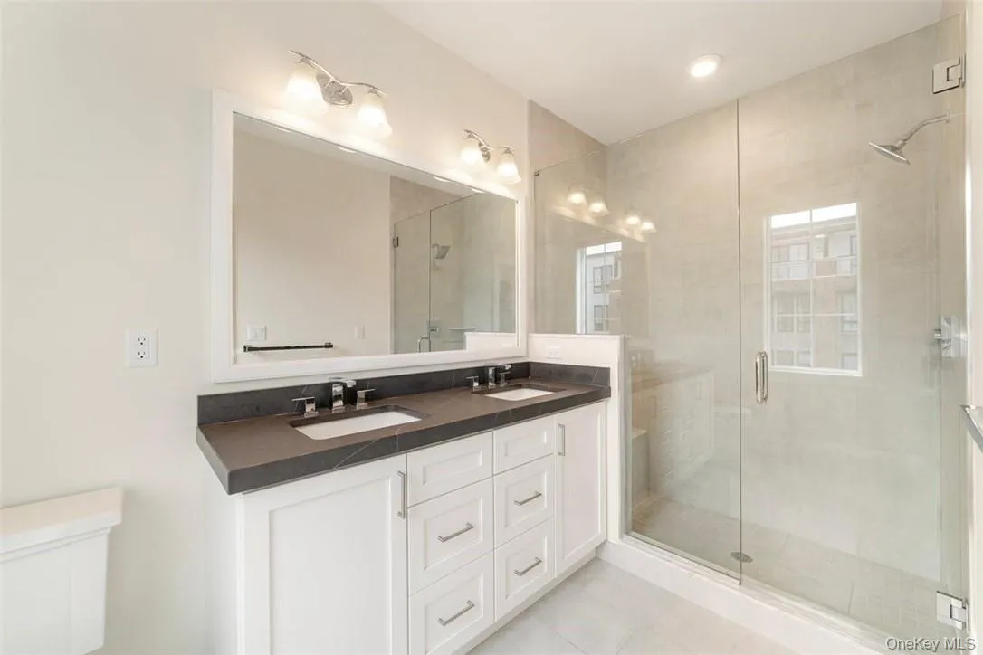Step-In Shower and Two-Sink Vanity in the Primary Bathroom Step-In Shower and Two-Sink Vanity in the Primary Bathroom
