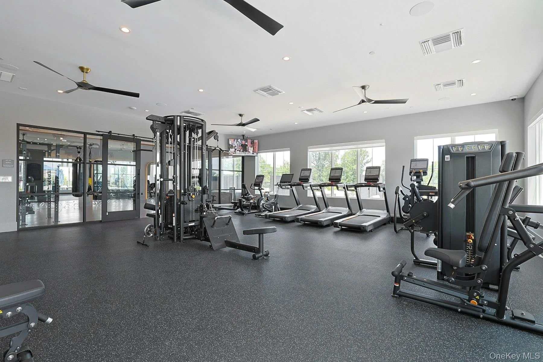 Exercise room with a ceiling fan and recessed lighting Exercise room with a ceiling fan and recessed lighting