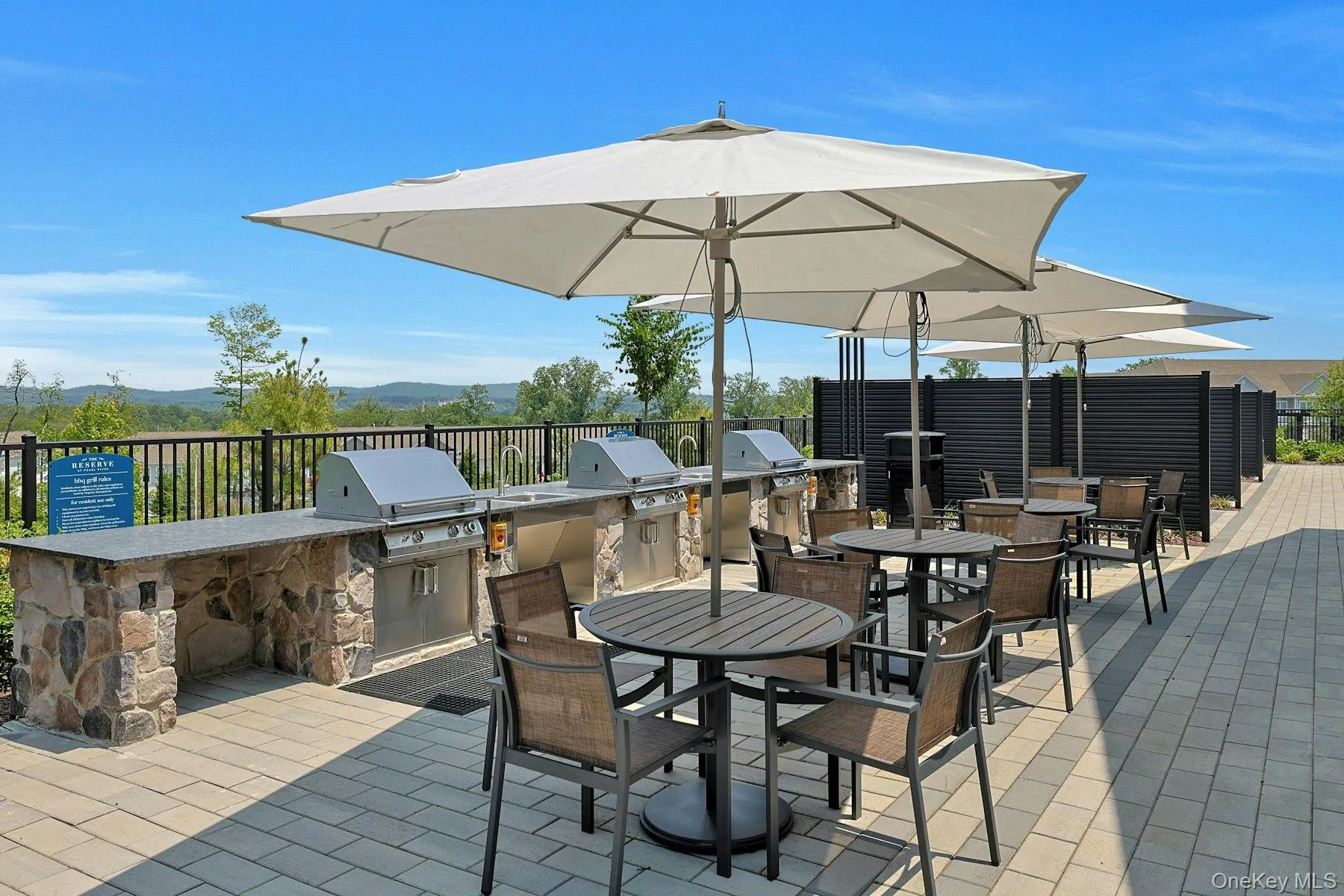 View of patio with an outdoor kitchen, outdoor dining area, and a mountain view View of patio with an outdoor kitchen, outdoor dining area, and a mountain view