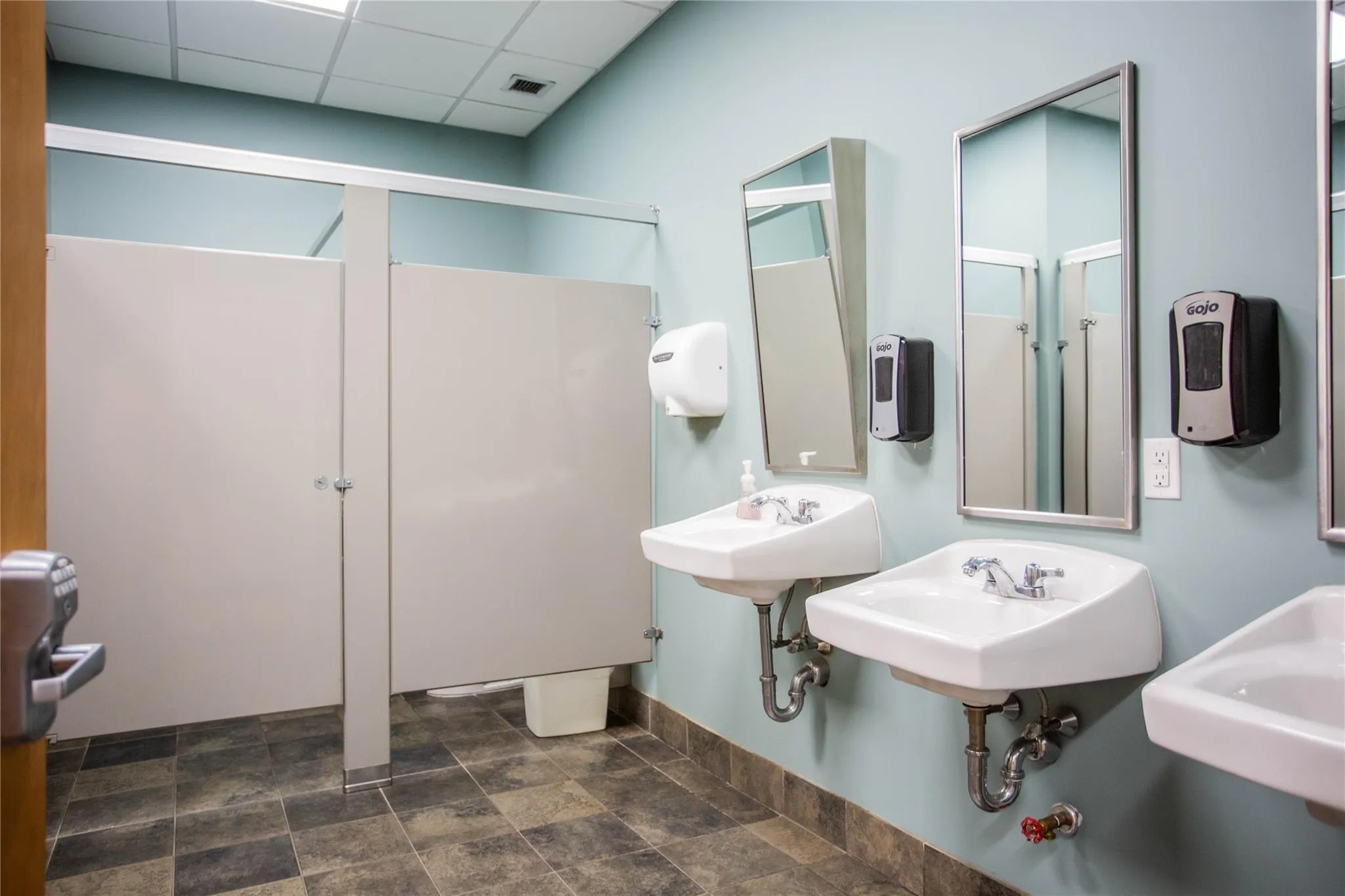 Full bath with a paneled ceiling, stone finish flooring, and a shower Full bath with a paneled ceiling, stone finish flooring, and a shower