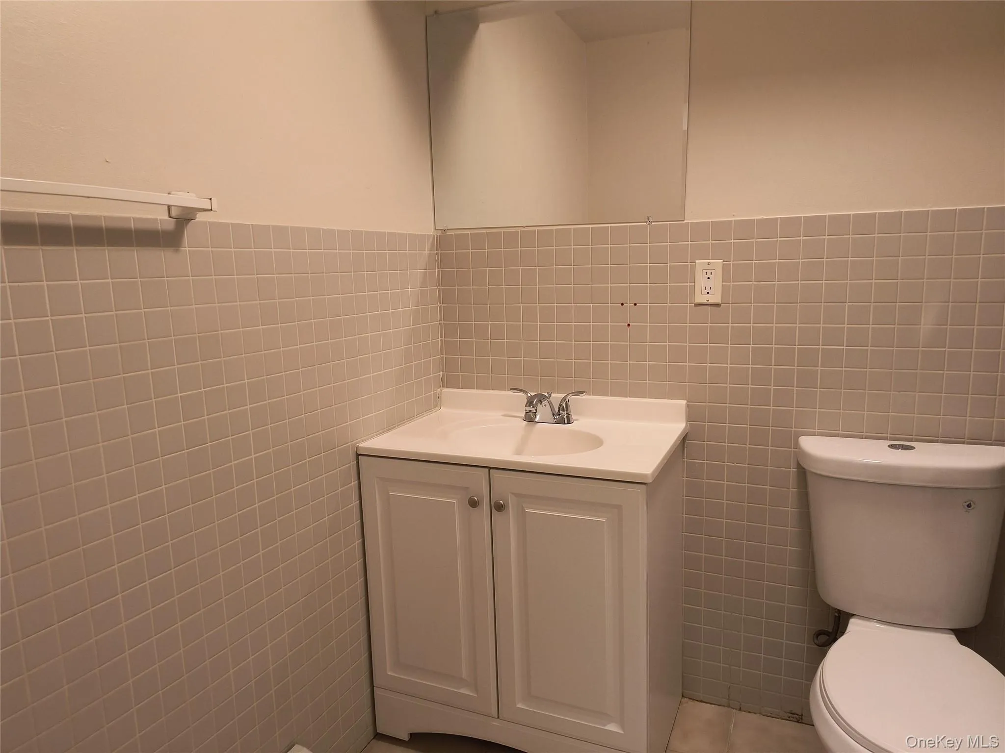 Bath vanity, tile walls and tile patterned flooring Bath vanity, tile walls and tile patterned flooring