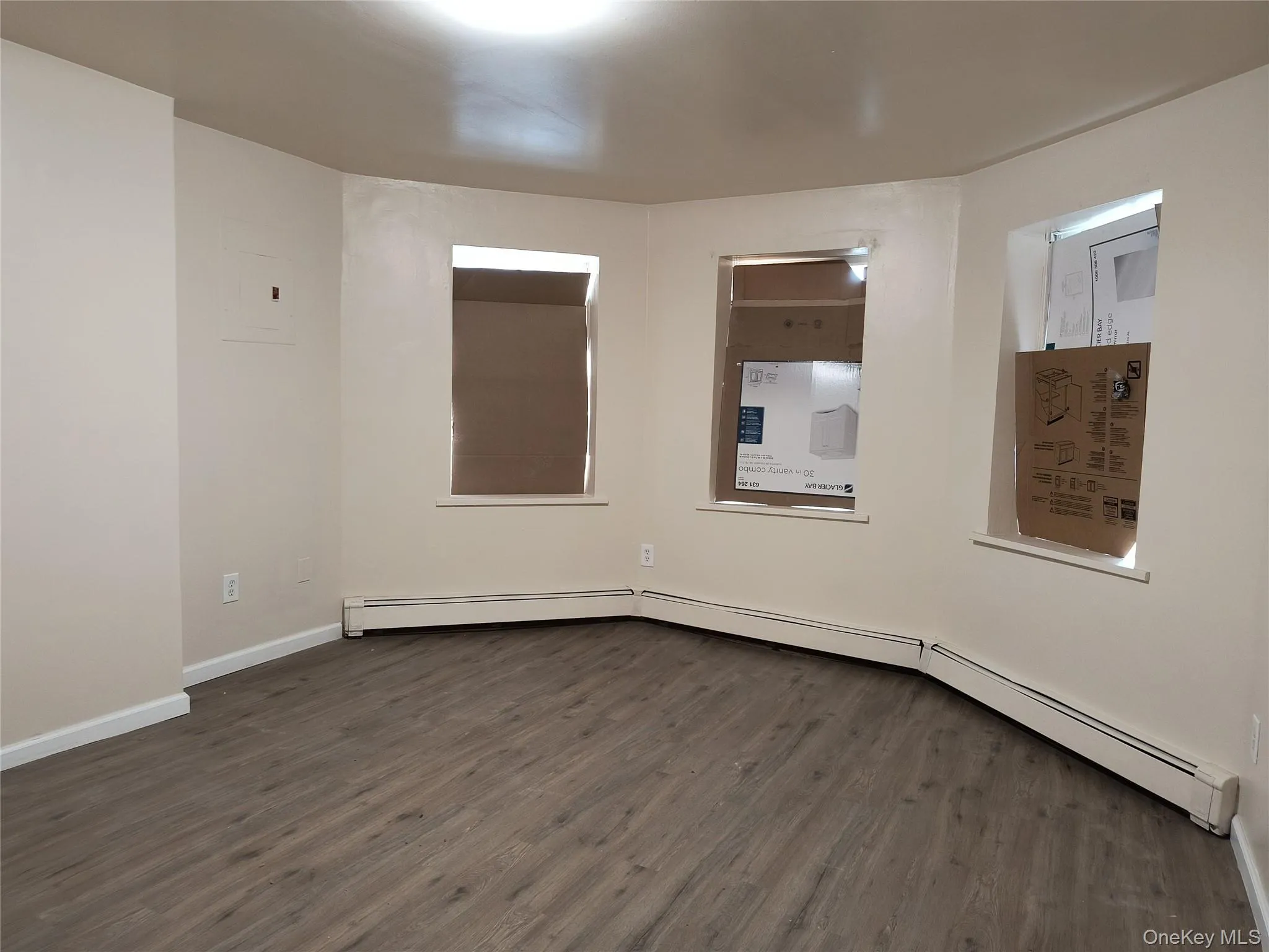 Unfurnished room with dark floors Unfurnished room with dark floors