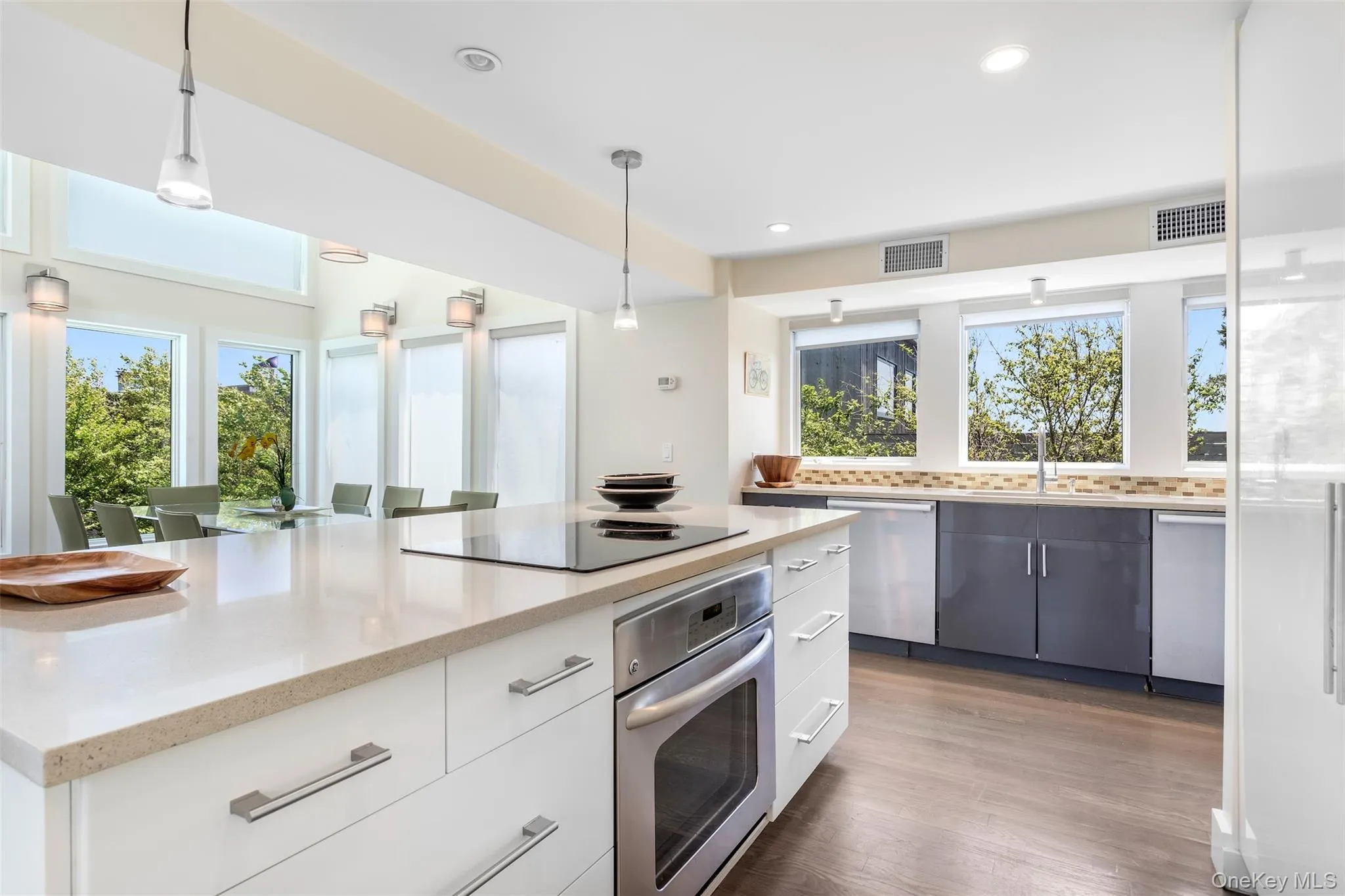 Kitchen with appliances with stainless steel finishes, healthy amount of natural light, recessed lighting, and pendant lighting Kitchen with appliances with stainless steel finishes, healthy amount of natural light, recessed lighting, and pendant lighting