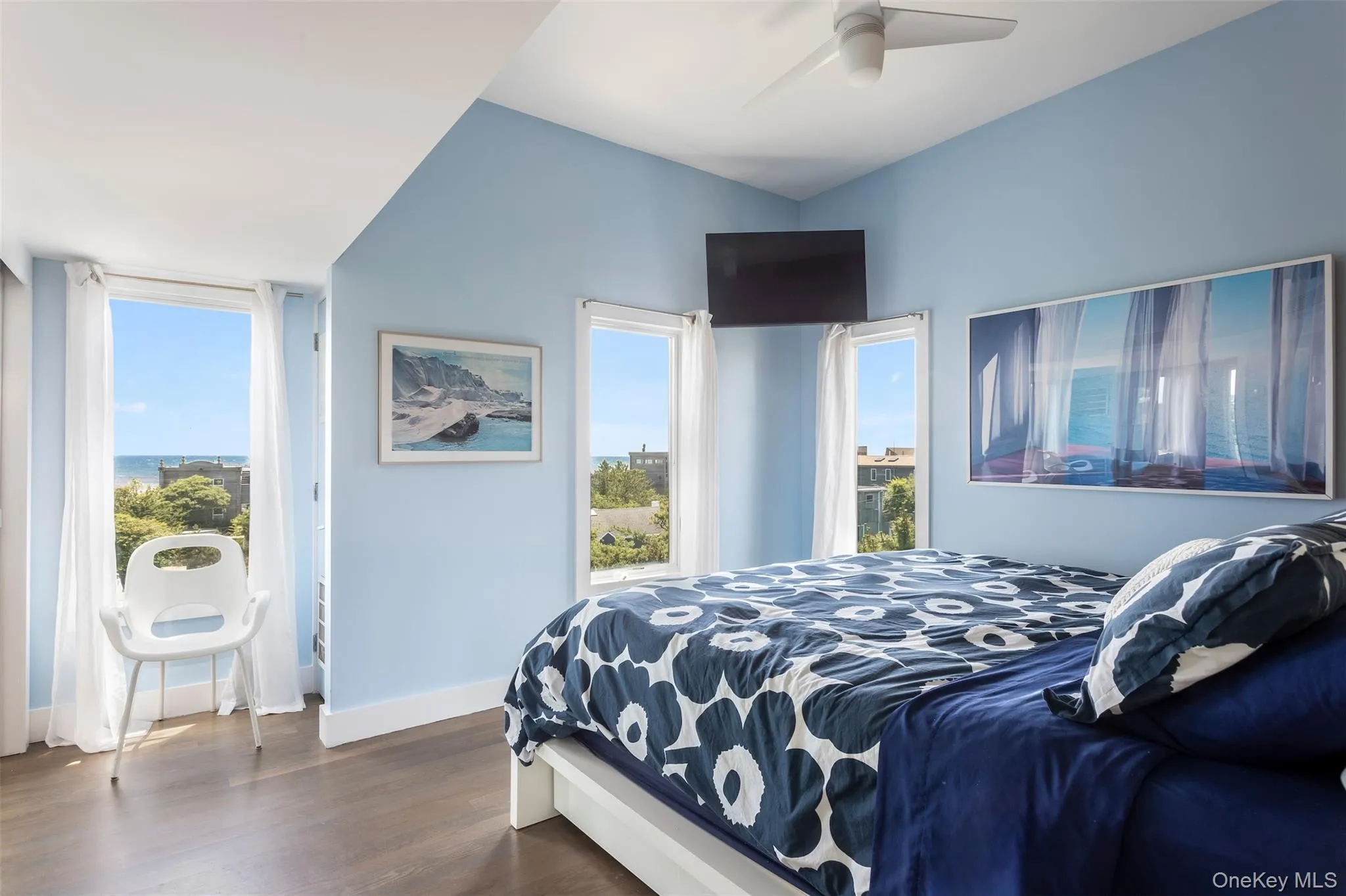 Bedroom with dark wood-style flooring and a ceiling fan Bedroom with dark wood-style flooring and a ceiling fan