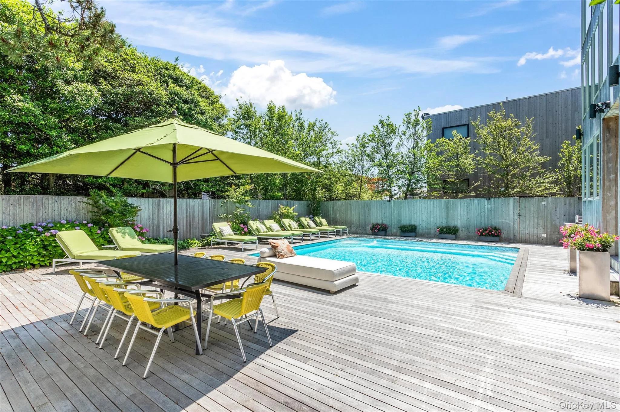 View of swimming pool with a fenced backyard, a deck, and outdoor dining space View of swimming pool with a fenced backyard, a deck, and outdoor dining space