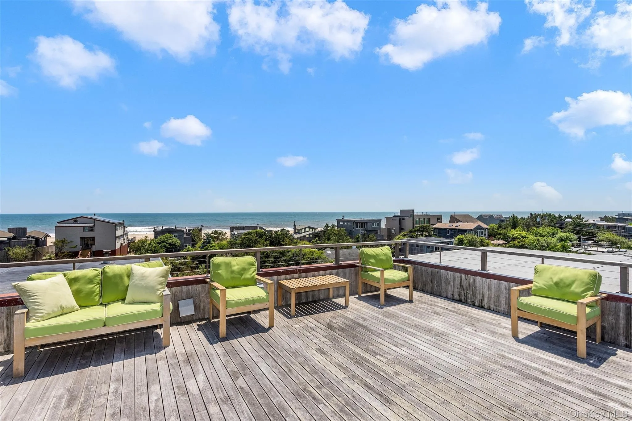 Wooden terrace featuring a water view and outdoor lounge area Wooden terrace featuring a water view and outdoor lounge area
