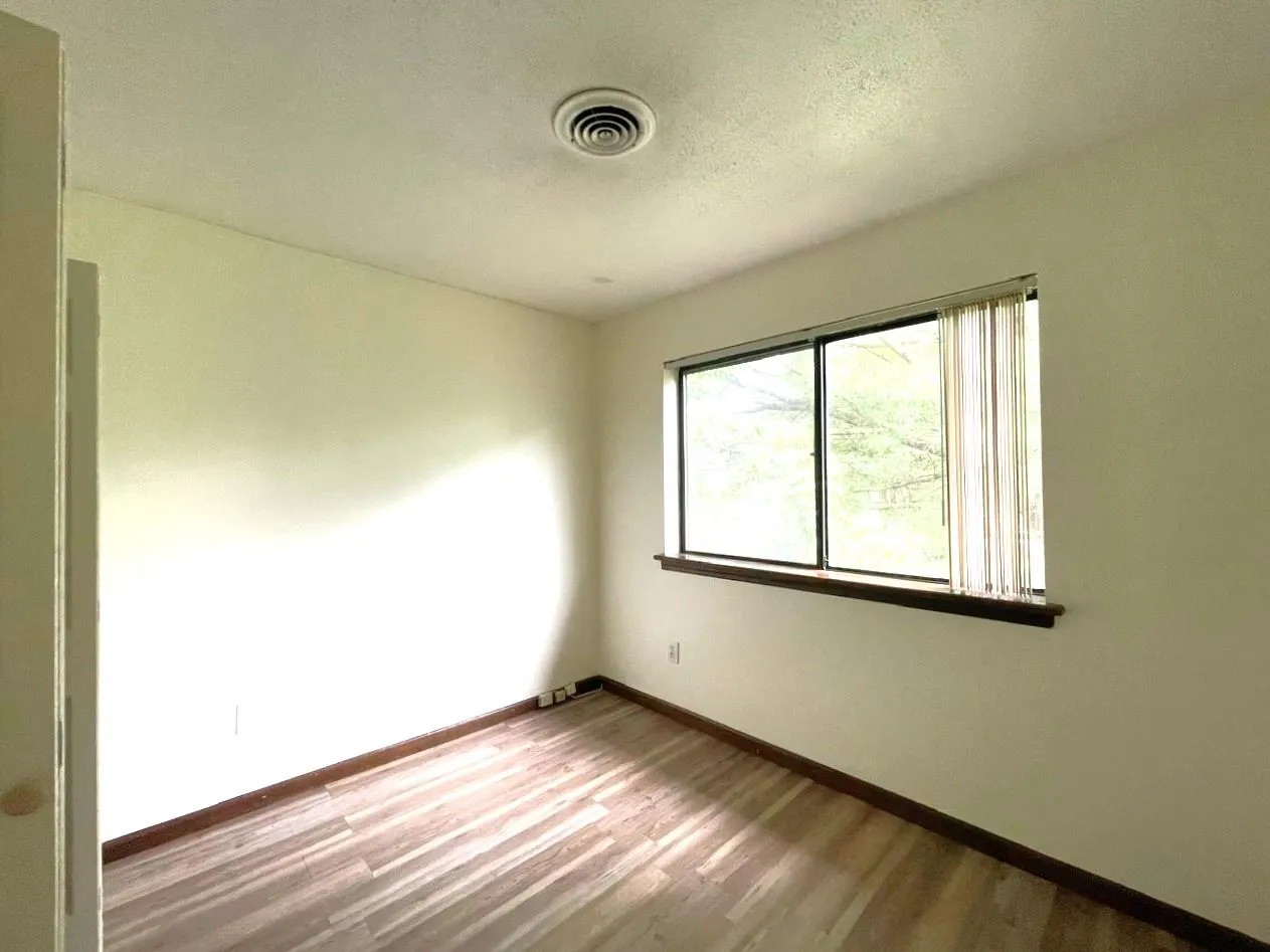 Unfurnished room featuring wood finished floors Unfurnished room featuring wood finished floors