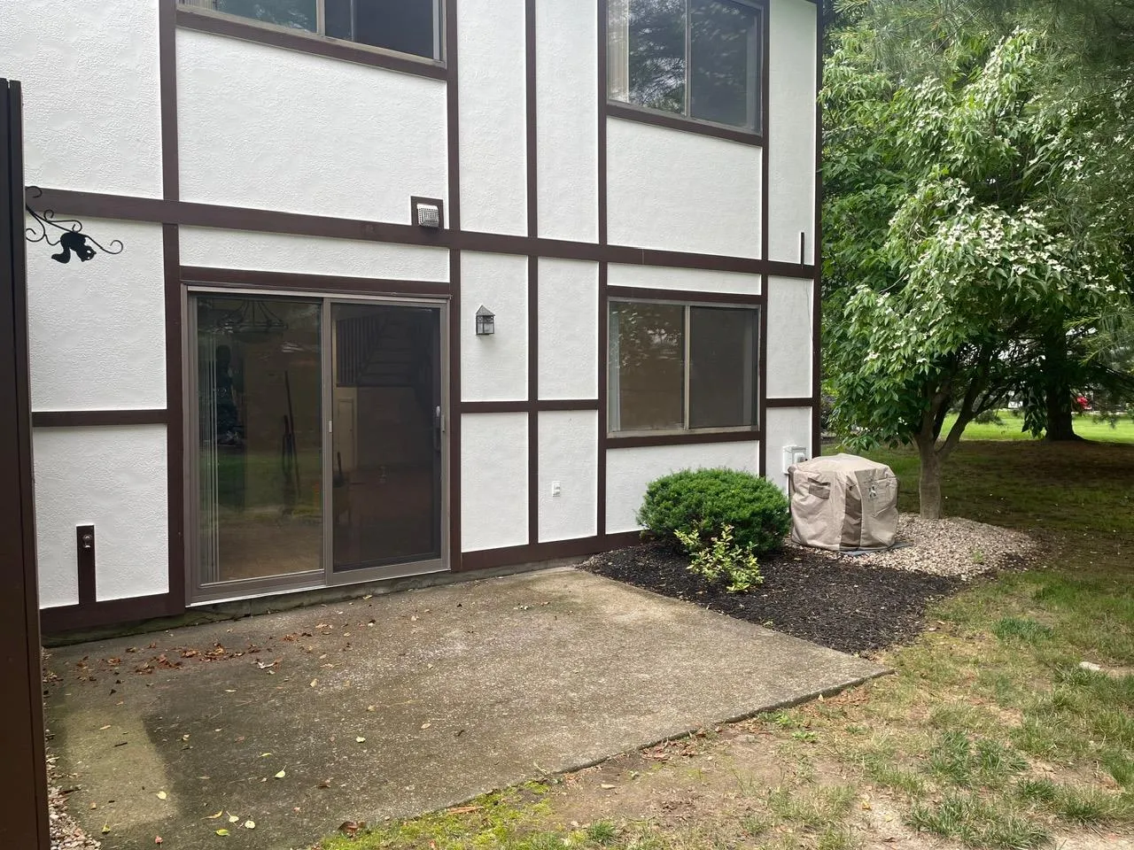 Entrance to property with stucco siding and a patio Entrance to property with stucco siding and a patio