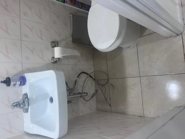 Half bath featuring tile patterned flooring and toilet Half bath featuring tile patterned flooring and toilet