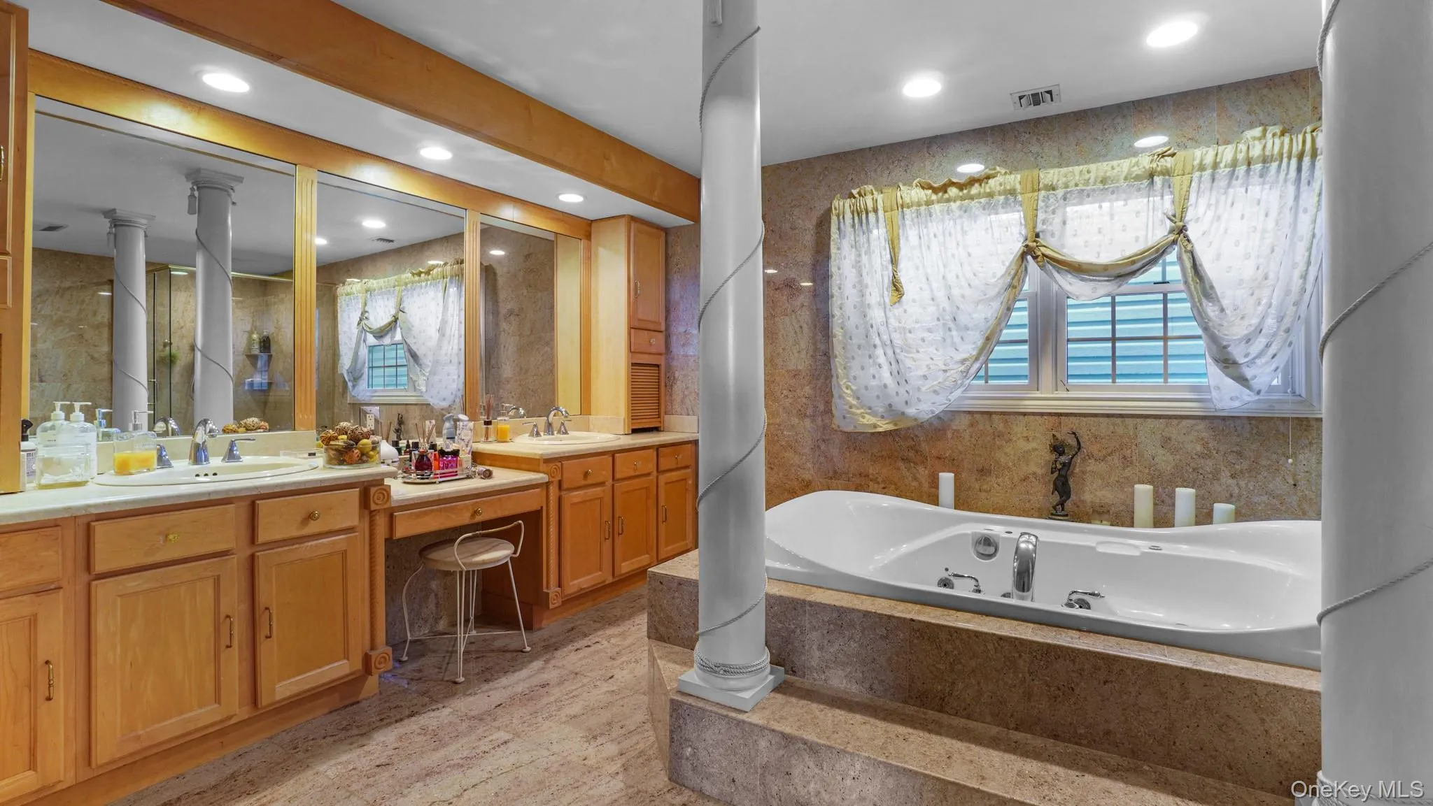 Bathroom with vanity, a tub with jets, and recessed lighting Bathroom with vanity, a tub with jets, and recessed lighting