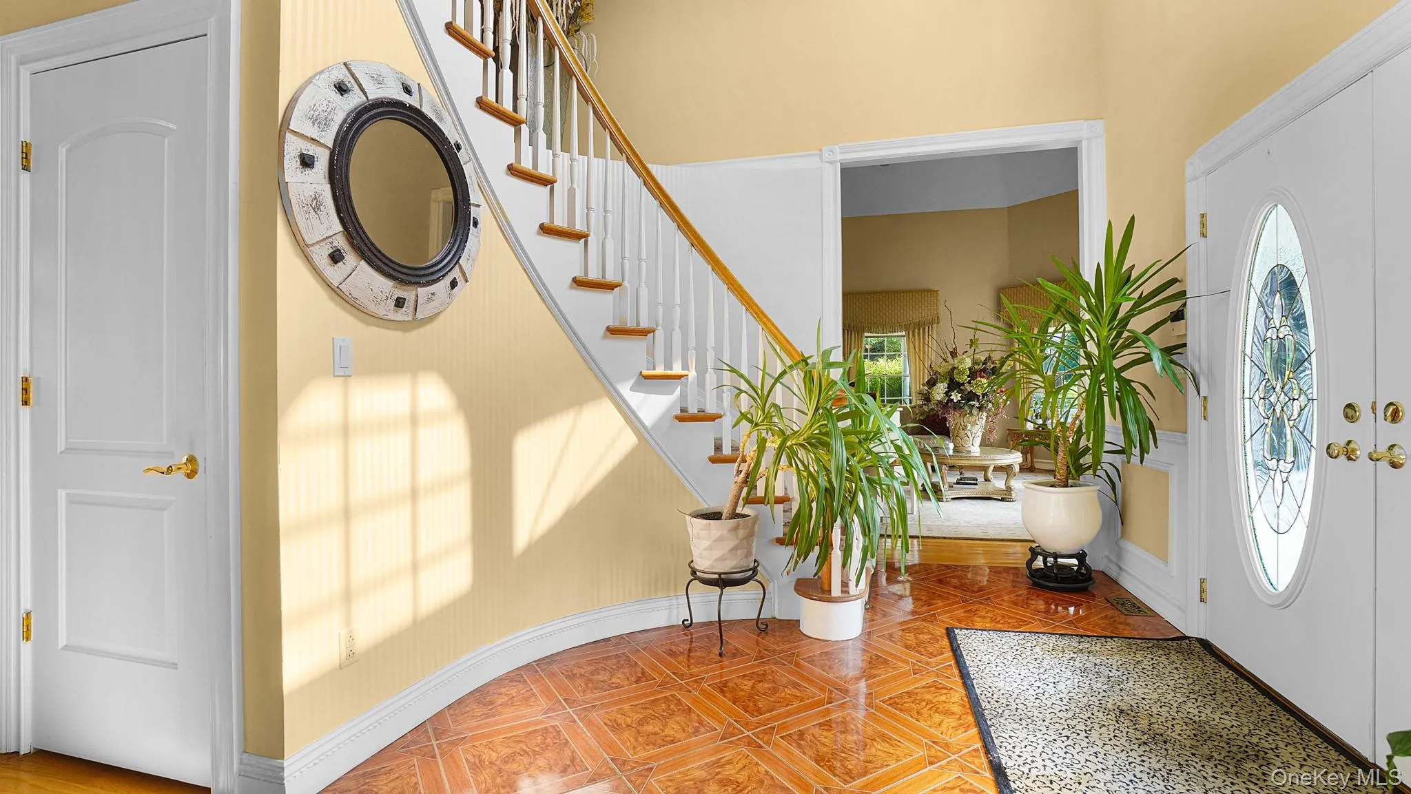 Entrance foyer featuring stairs and baseboards Entrance foyer featuring stairs and baseboards