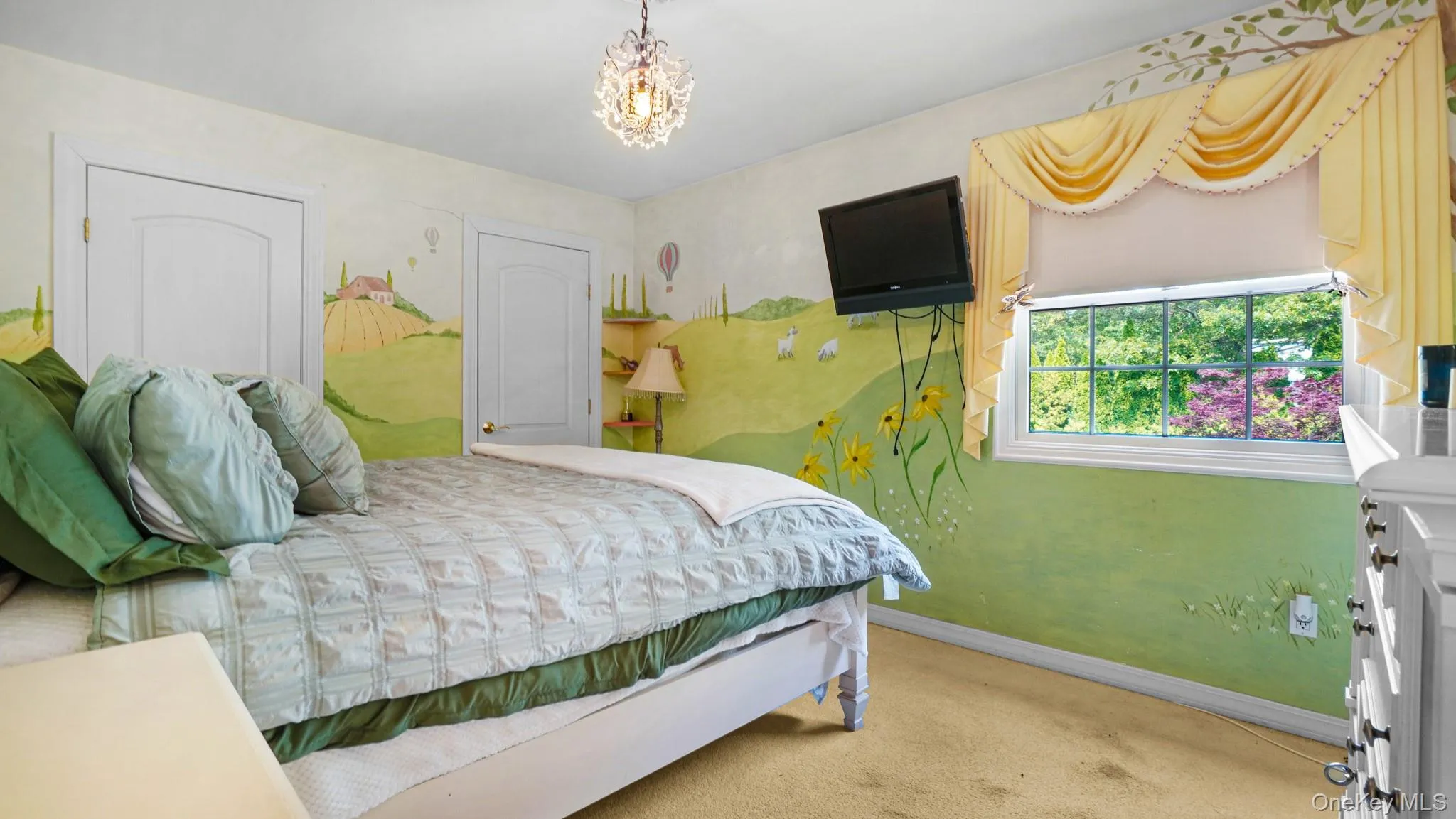 Carpeted bedroom with baseboards and a chandelier Carpeted bedroom with baseboards and a chandelier