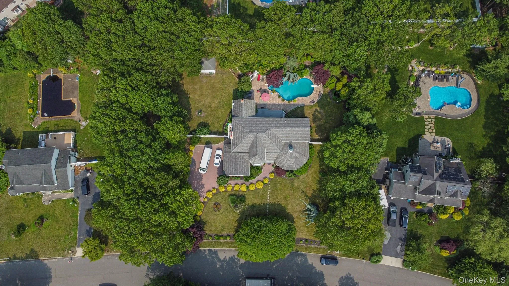 Aerial view of property's location with a pool Aerial view of property's location with a pool