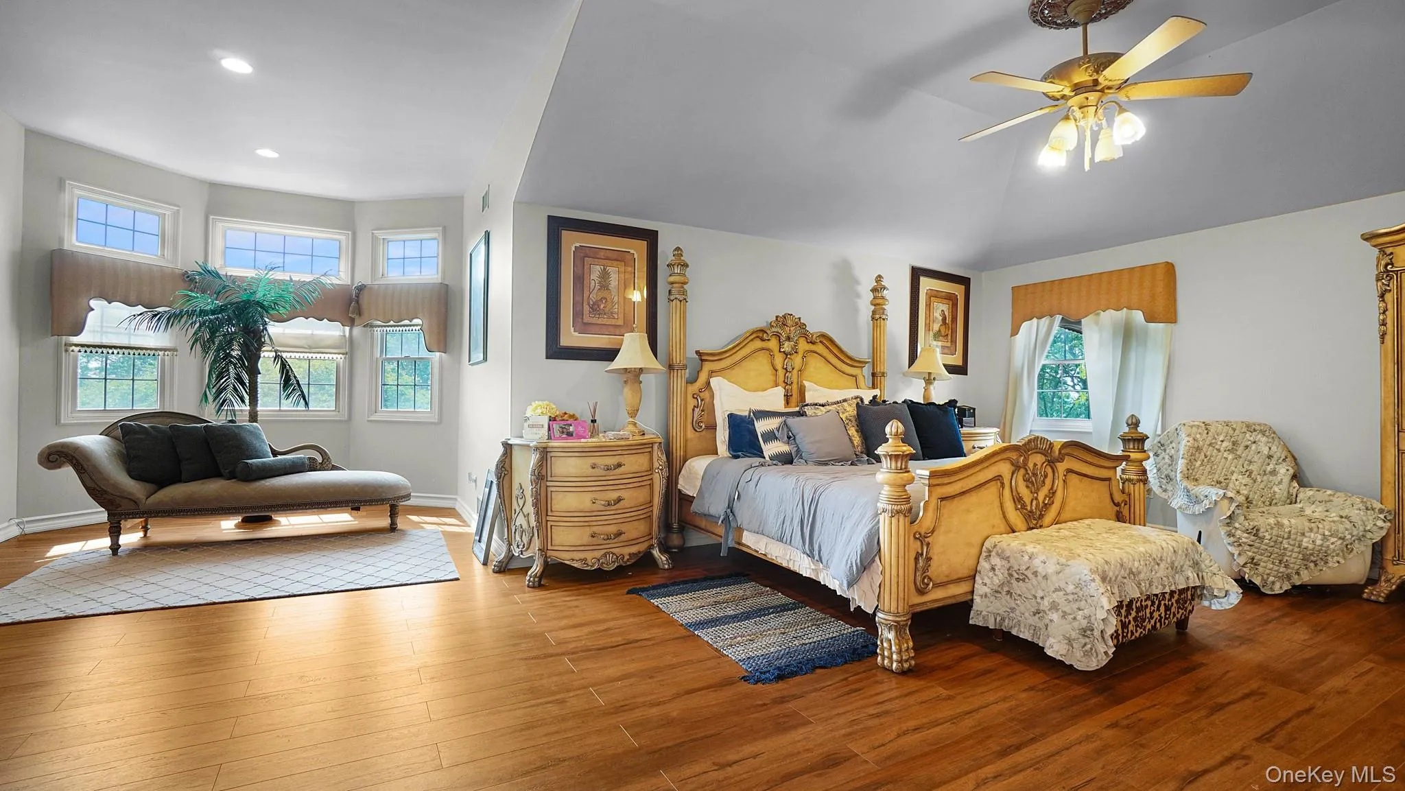 Bedroom with wood finished floors, recessed lighting, and a ceiling fan Bedroom with wood finished floors, recessed lighting, and a ceiling fan