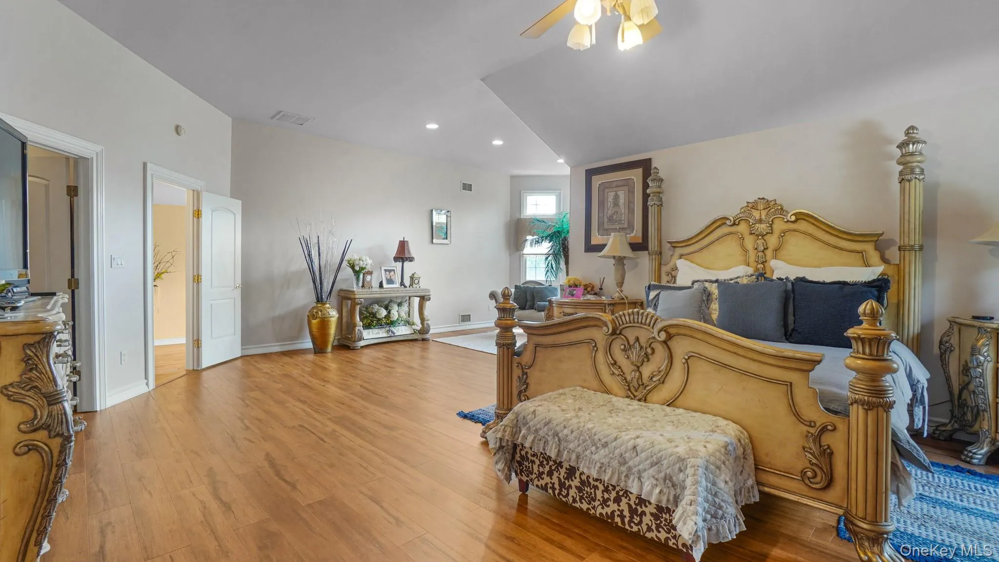 Bedroom with wood finished floors, recessed lighting, and a ceiling fan Bedroom with wood finished floors, recessed lighting, and a ceiling fan