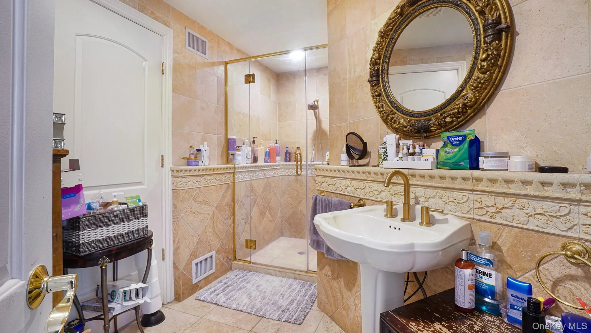 Bathroom with tile walls, tile patterned flooring, and a shower stall Bathroom with tile walls, tile patterned flooring, and a shower stall