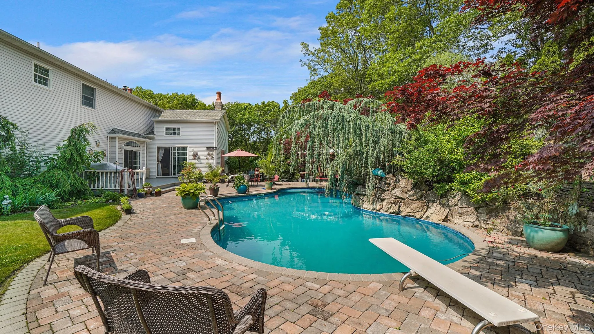 Swimming pool with a patio and a diving board Swimming pool with a patio and a diving board