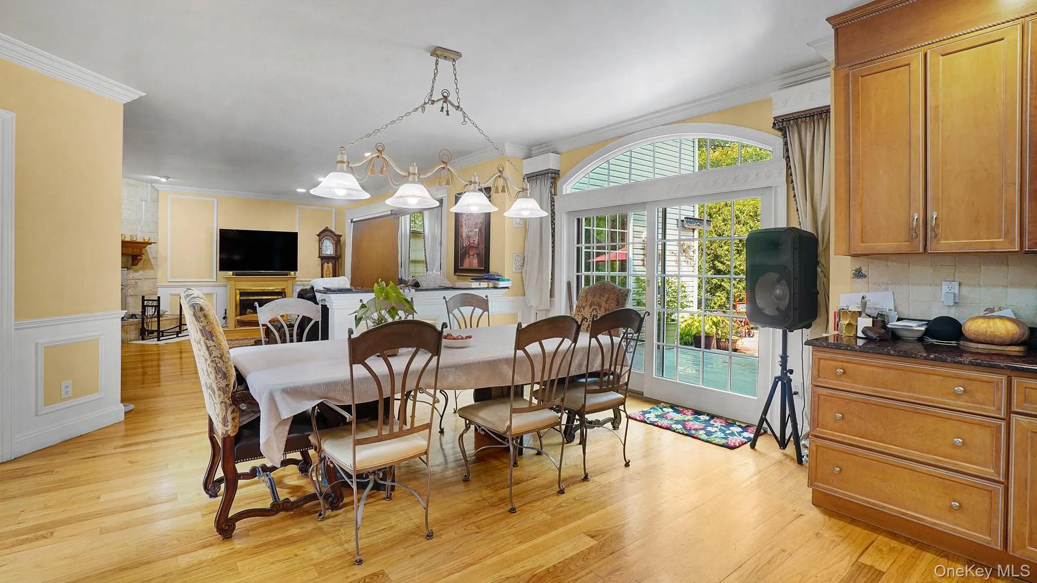 Dining space with ornamental molding, light wood-style floors, and wainscoting Dining space with ornamental molding, light wood-style floors, and wainscoting
