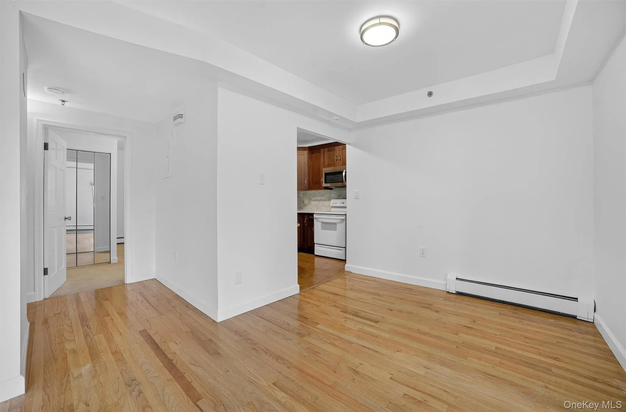 Dining room, light wood-type flooring, and a raised ceiling Dining room, light wood-type flooring, and a raised ceiling