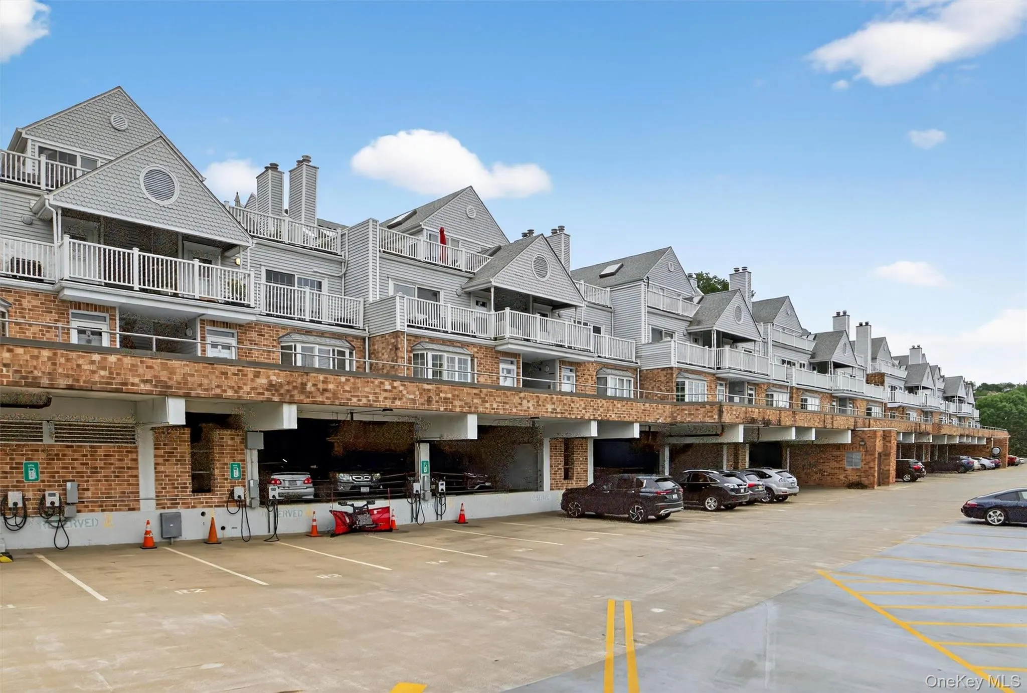 View of building exterior with uncovered parking View of building exterior with uncovered parking