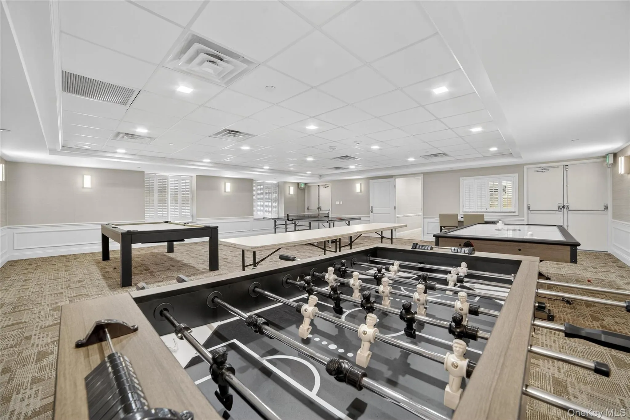 Rec room with a decorative wall, carpet floors, billiards table, and a wainscoted wall Rec room with a decorative wall, carpet floors, billiards table, and a wainscoted wall