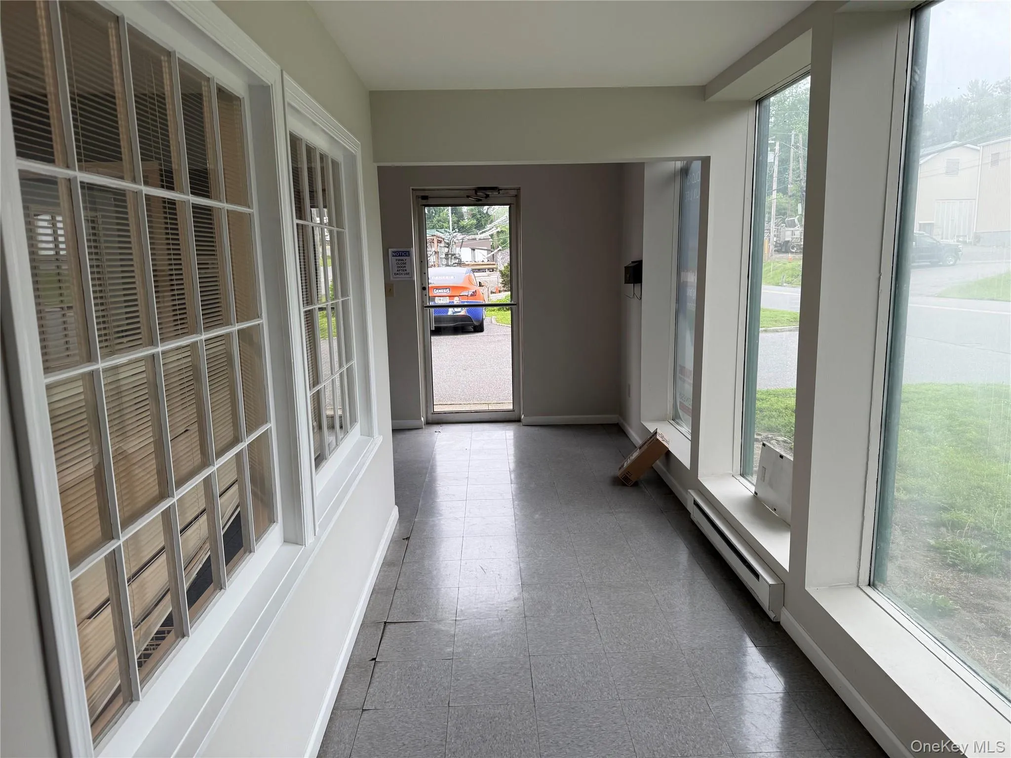 Unfurnished sunroom with baseboard heating Unfurnished sunroom with baseboard heating