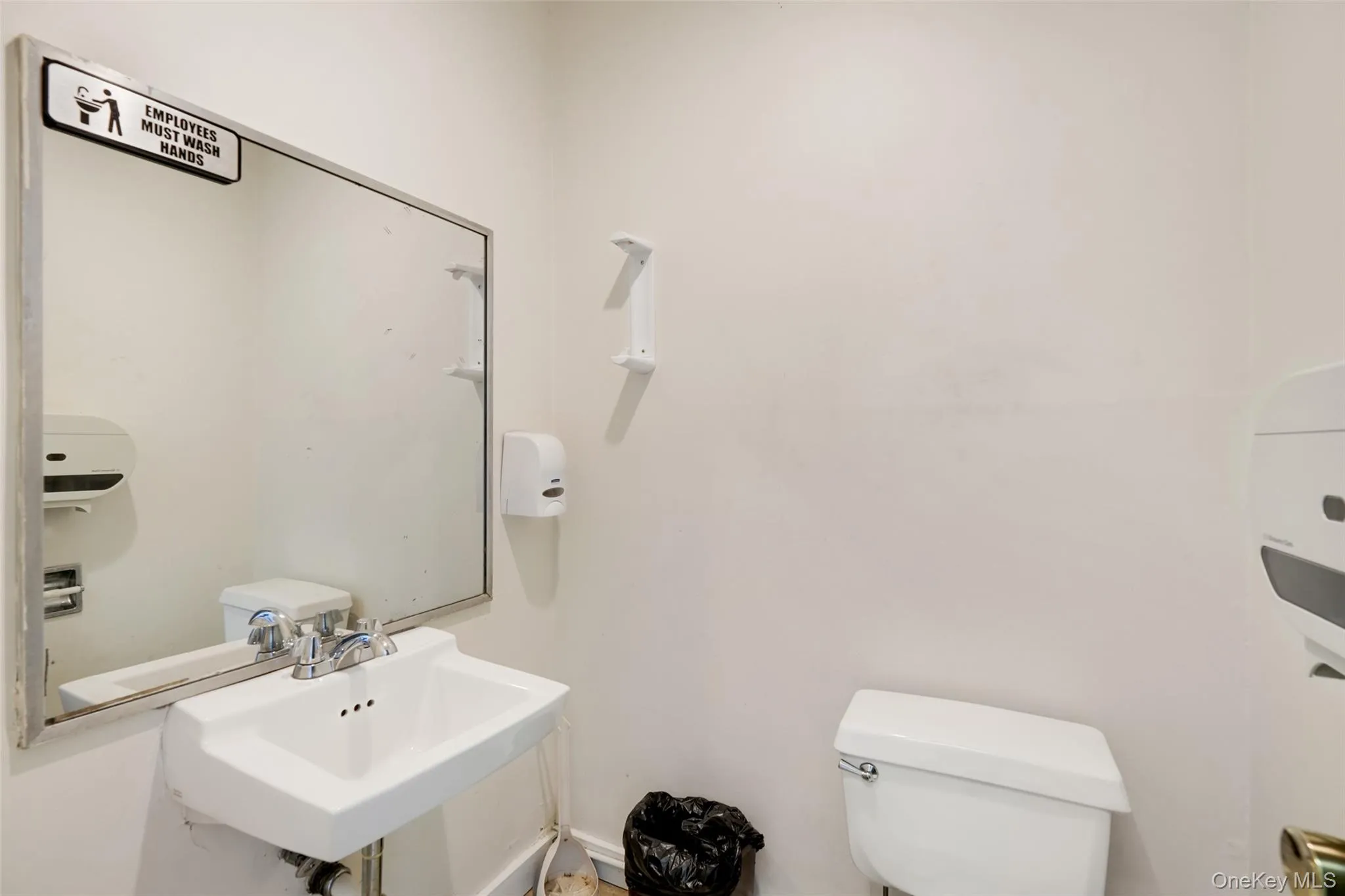 Bathroom featuring toilet and a sink Bathroom featuring toilet and a sink