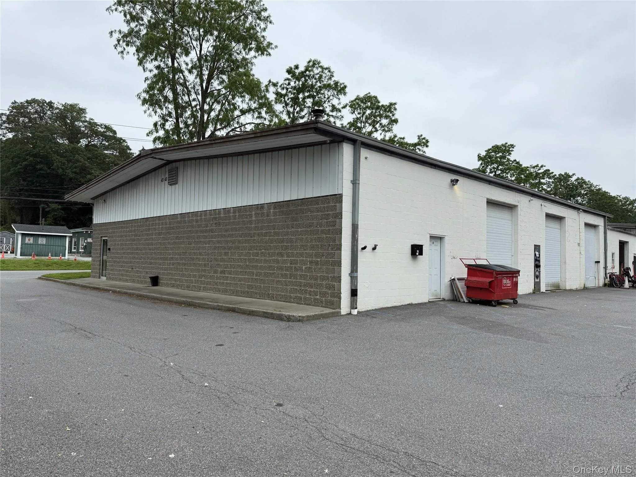 View of property exterior with concrete block siding and a garage View of property exterior with concrete block siding and a garage