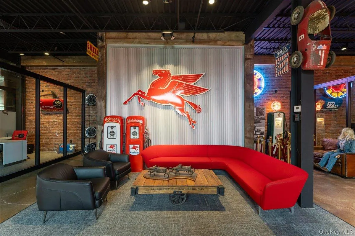 Community lobby featuring brick wall and a towering ceiling Community lobby featuring brick wall and a towering ceiling