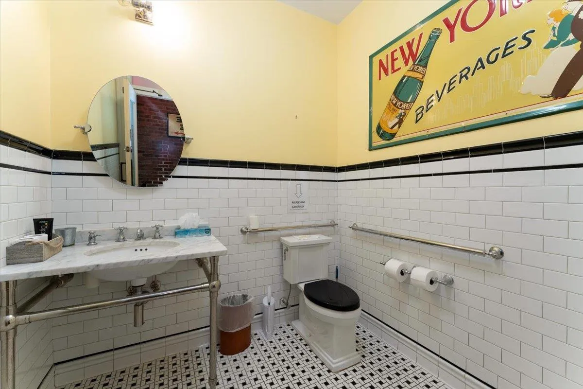 Half bath with a wainscoted wall, tile walls, and tile patterned flooring Half bath with a wainscoted wall, tile walls, and tile patterned flooring