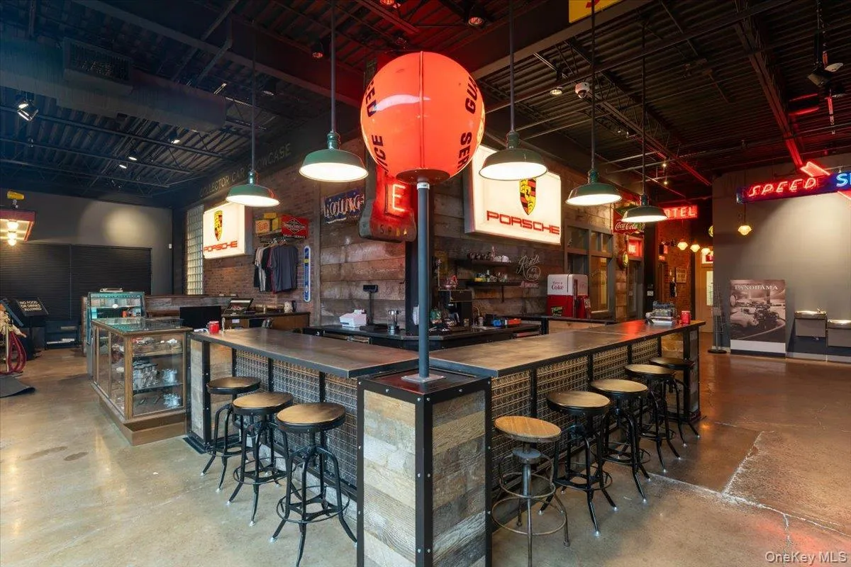 Community bar area with concrete floors and beverage cooler Community bar area with concrete floors and beverage cooler