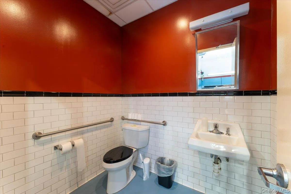 Bathroom featuring a wainscoted wall and tile walls Bathroom featuring a wainscoted wall and tile walls