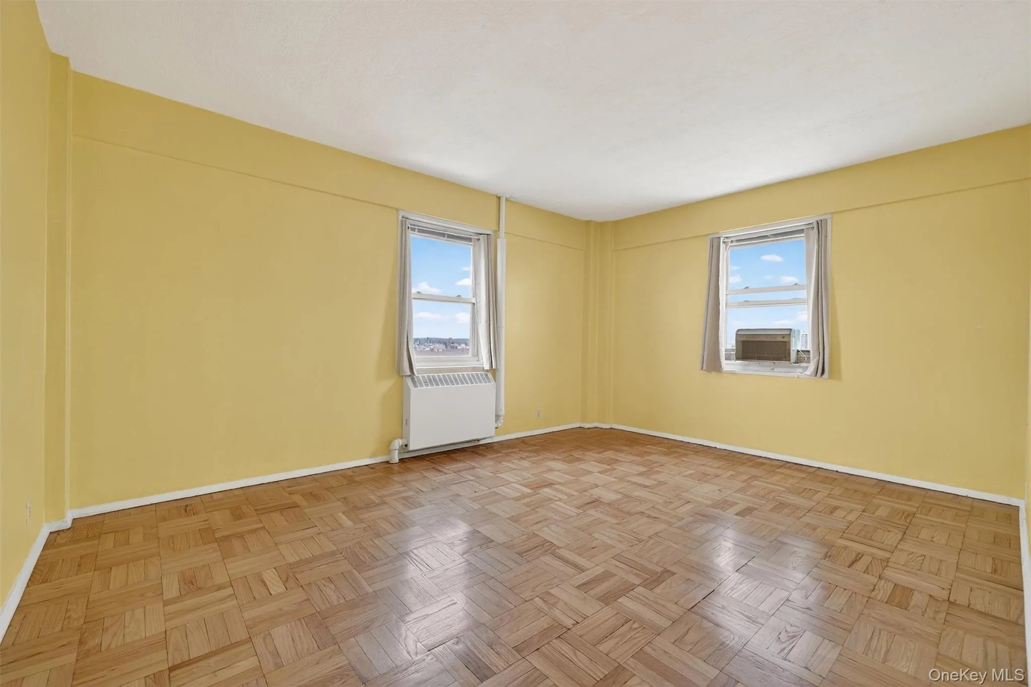 Primary Bedroom Unfurnished room featuring radiator heating unit and plenty of natural light Primary Bedroom Unfurnished room featuring radiator heating unit and plenty of natural light