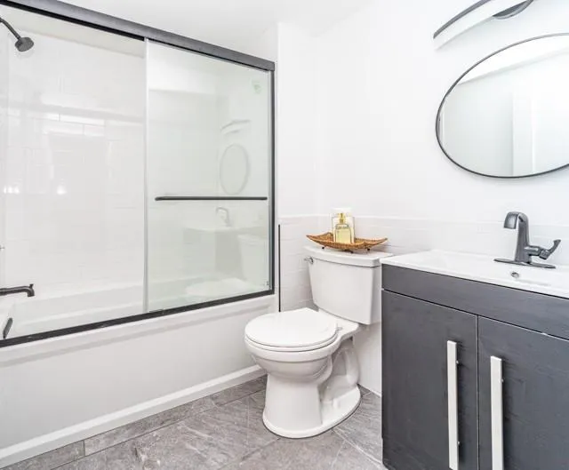 Bathroom with vanity and bath / shower combo with glass door Bathroom with vanity and bath / shower combo with glass door