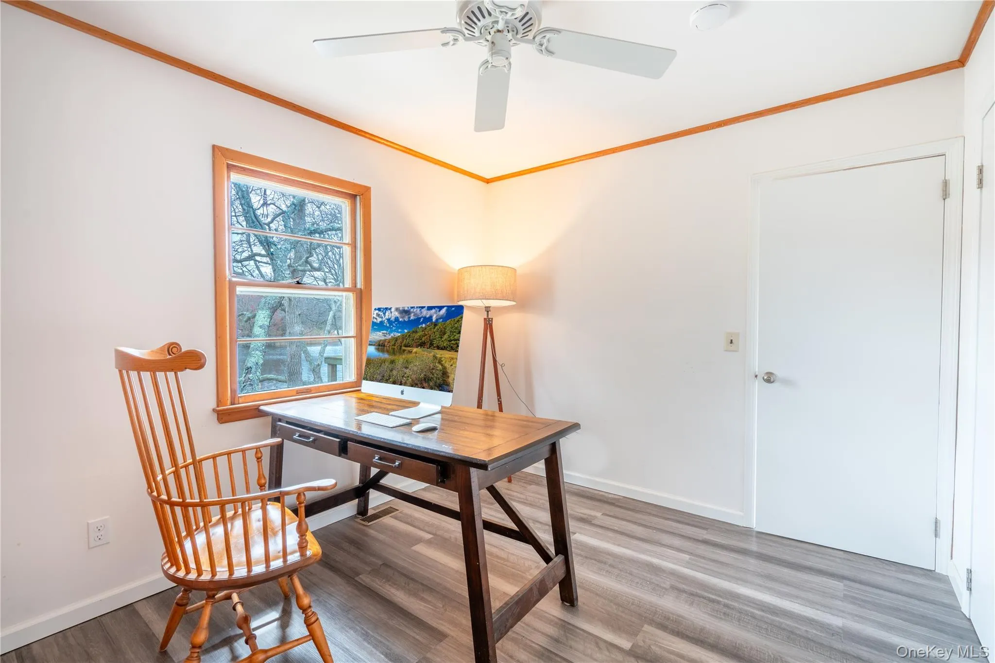 Office space featuring wood finished floors, ceiling fan, and ornamental molding Office space featuring wood finished floors, ceiling fan, and ornamental molding