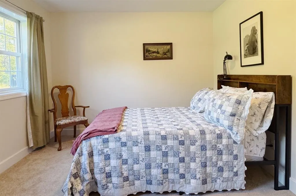 Carpeted bedroom featuring baseboards Carpeted bedroom featuring baseboards