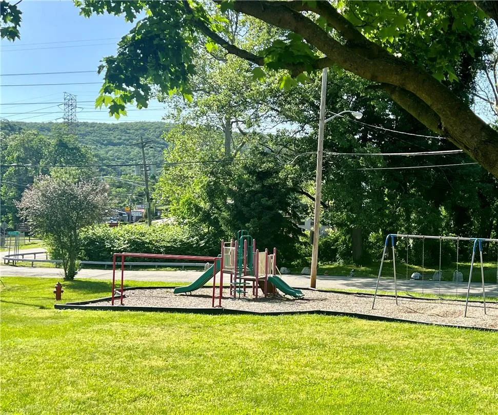 View of home's community featuring a playground and a lawn View of home's community featuring a playground and a lawn