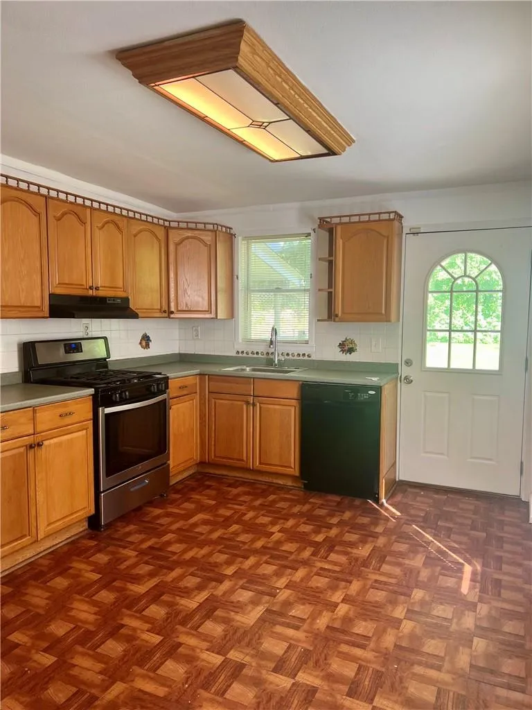Kitchen featuring black dishwasher, stainless steel gas stove Kitchen featuring black dishwasher, stainless steel gas stove