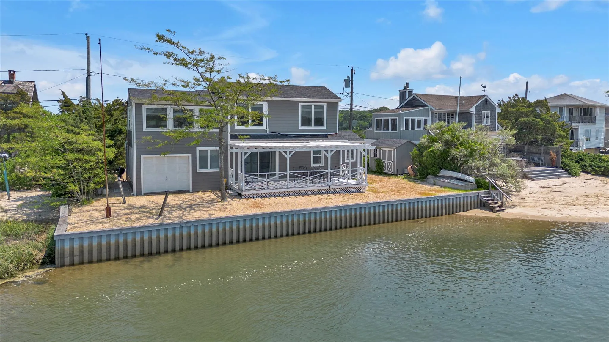 Rear view of property with a deck with water view Rear view of property with a deck with water view