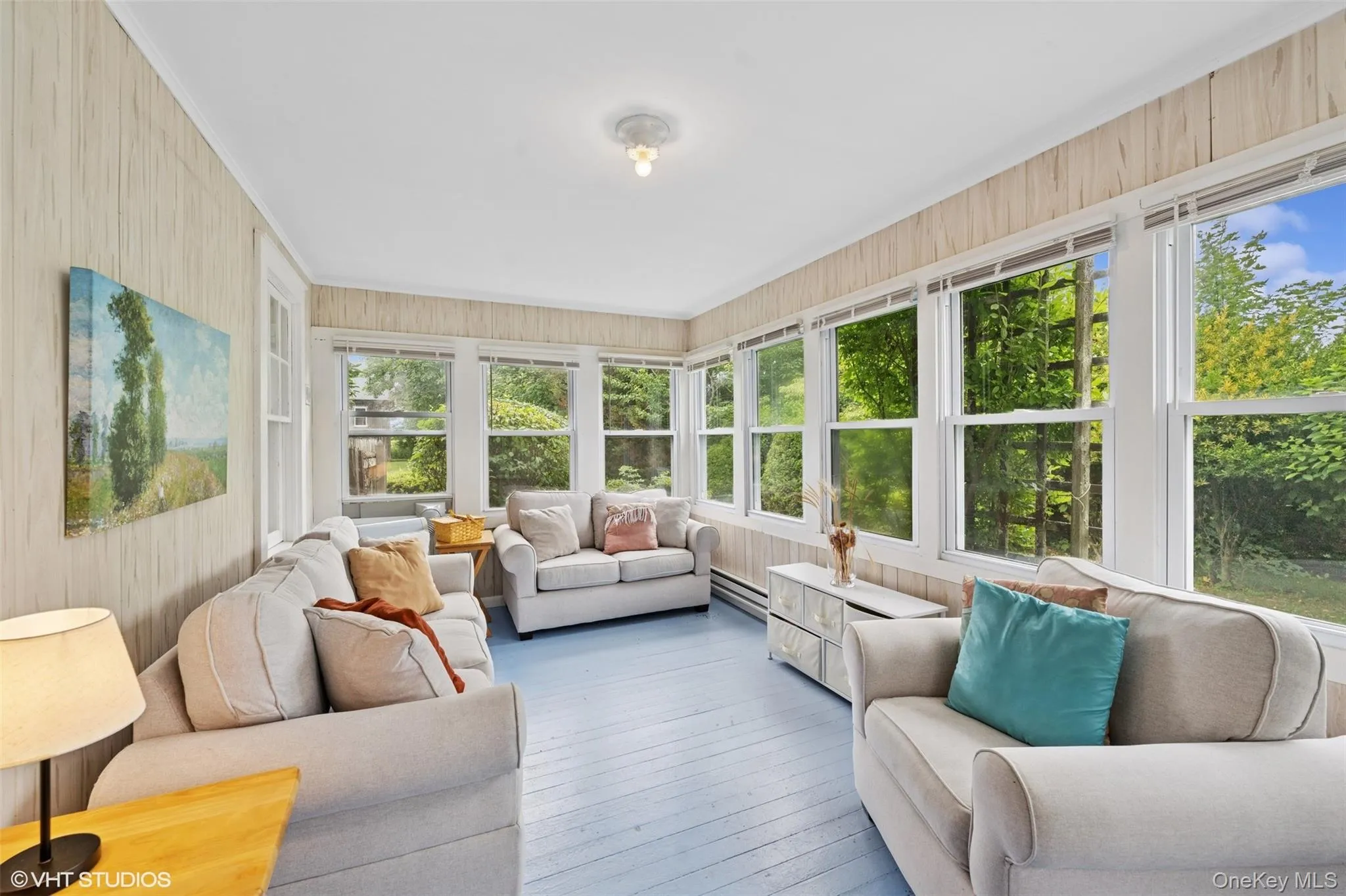 Sunroom with hardwood / wood-style flooring, wooden walls, and a baseboard radiator Sunroom with hardwood / wood-style flooring, wooden walls, and a baseboard radiator