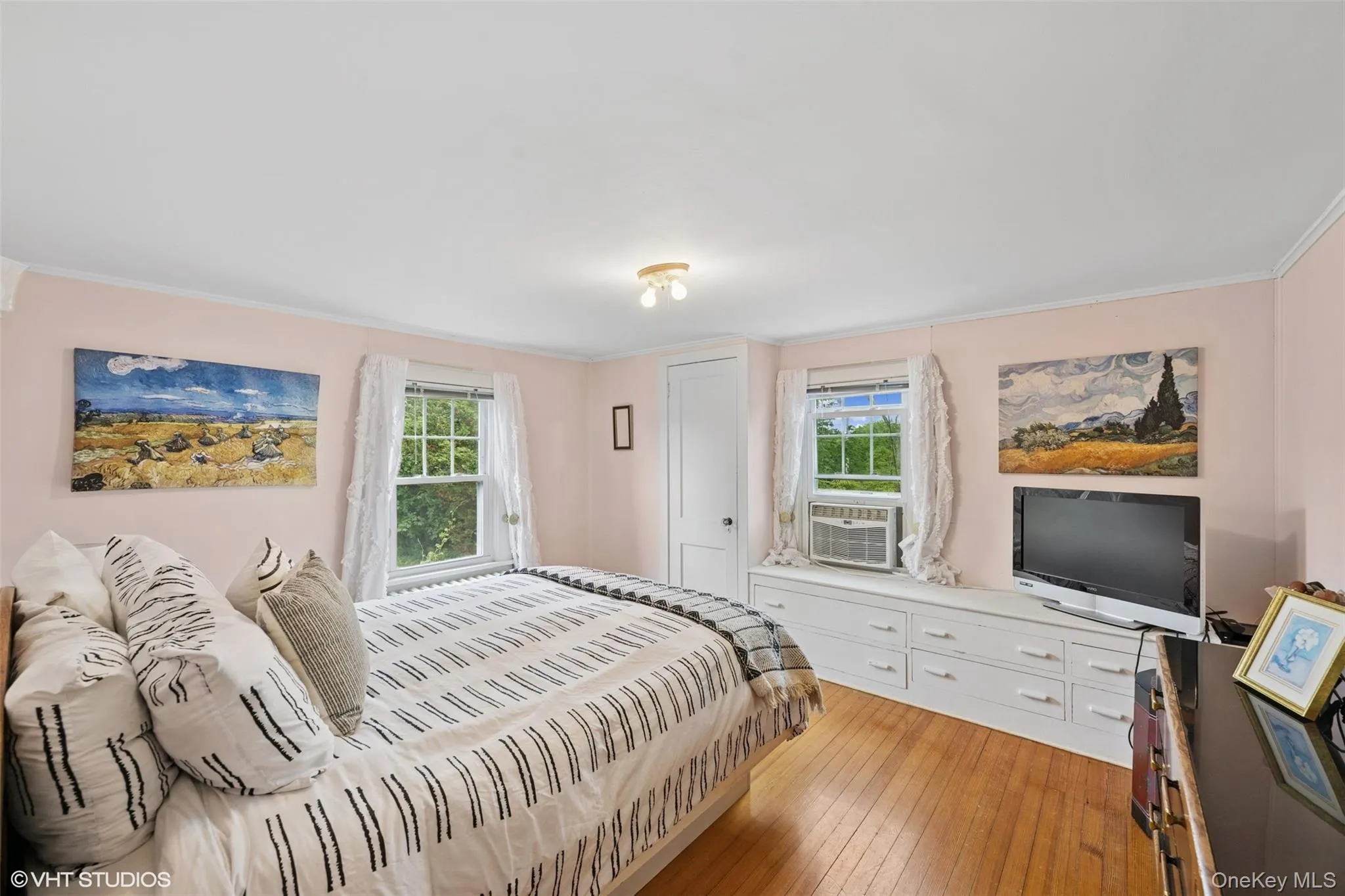Bedroom featuring ornamental molding, hardwood / wood-style floors, and cooling unit Bedroom featuring ornamental molding, hardwood / wood-style floors, and cooling unit