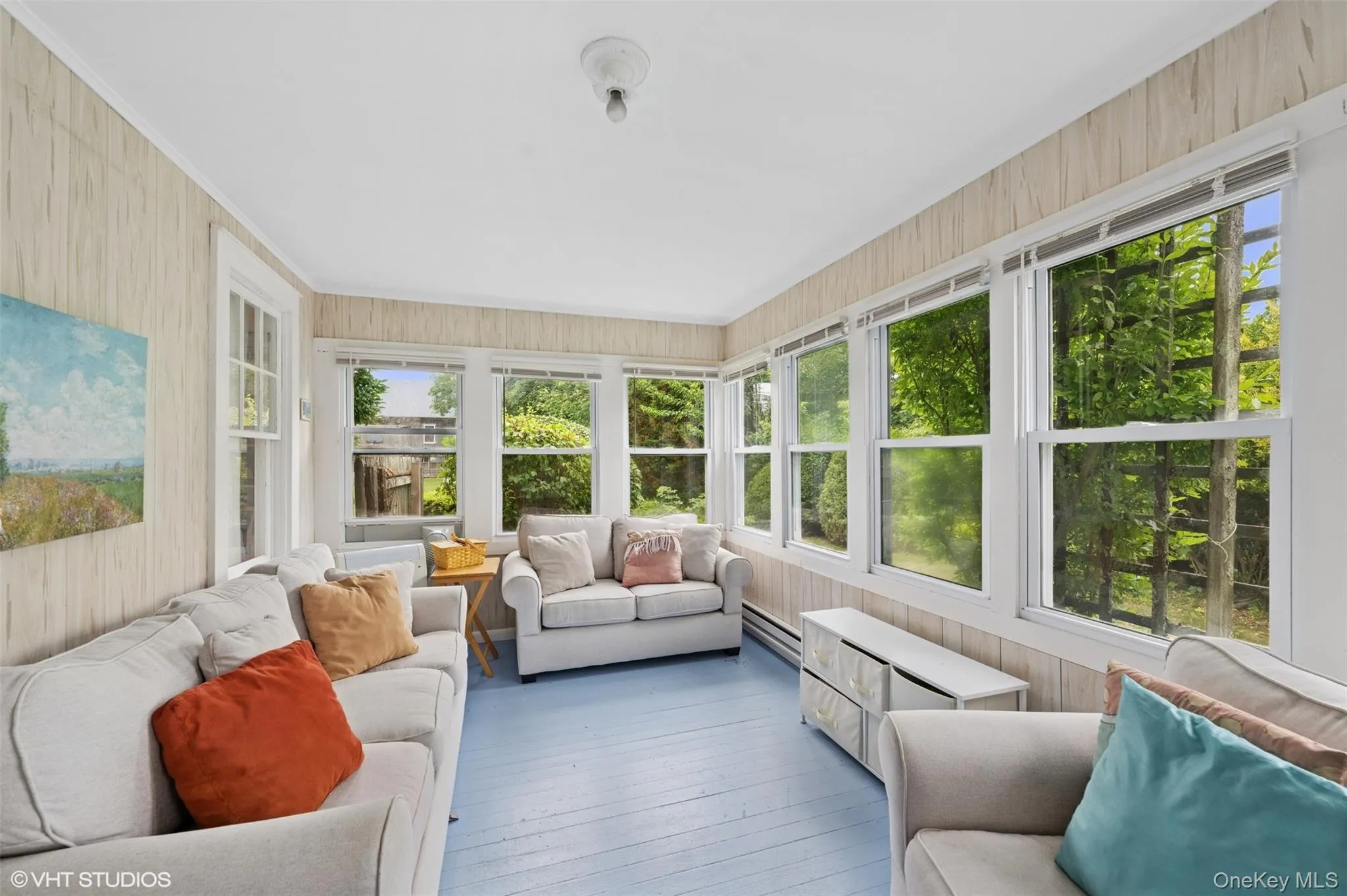 Sunroom / solarium featuring an outdoor hangout area and a baseboard heating unit Sunroom / solarium featuring an outdoor hangout area and a baseboard heating unit