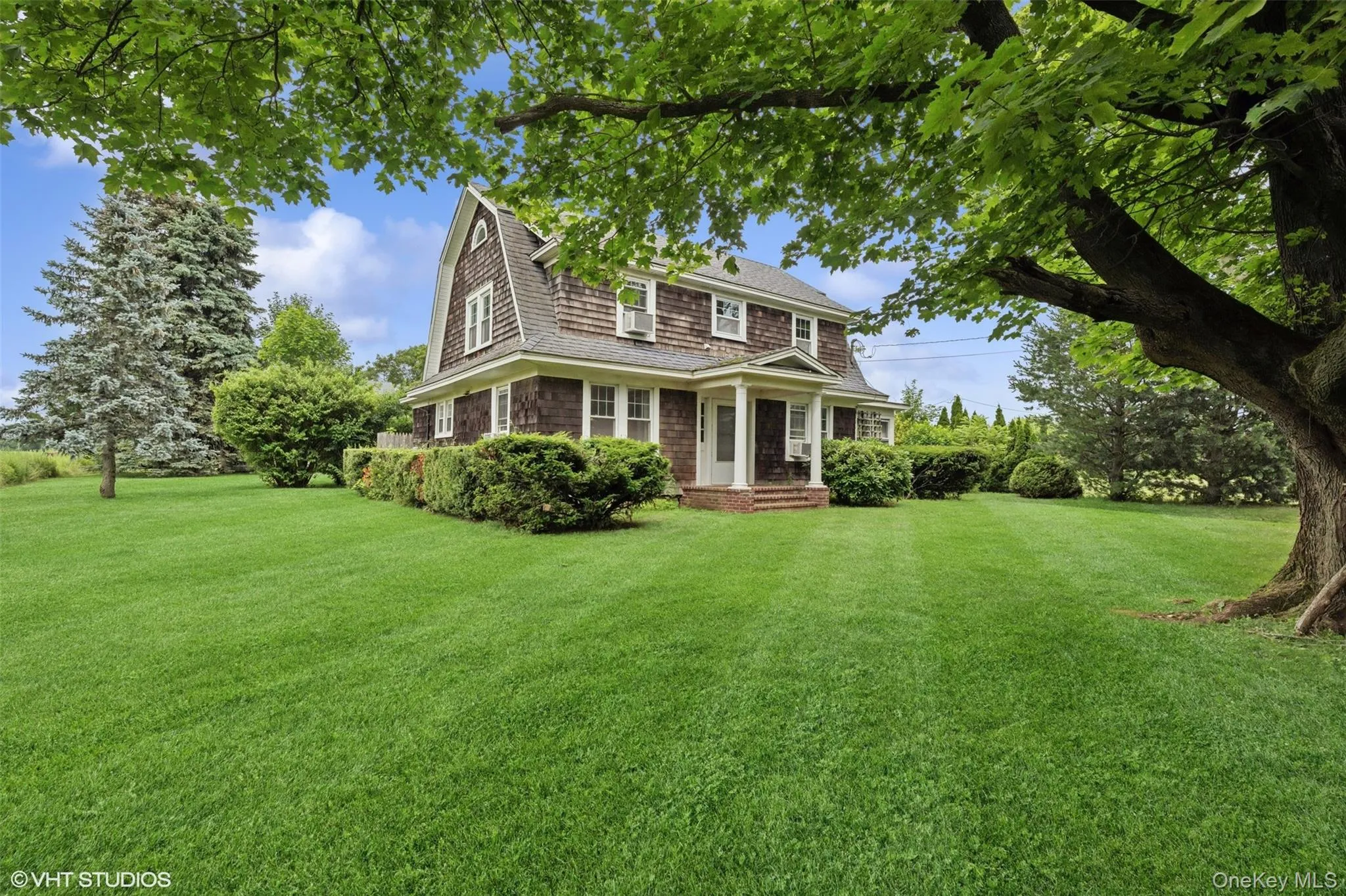 Shingle-style home with a front lawn Shingle-style home with a front lawn