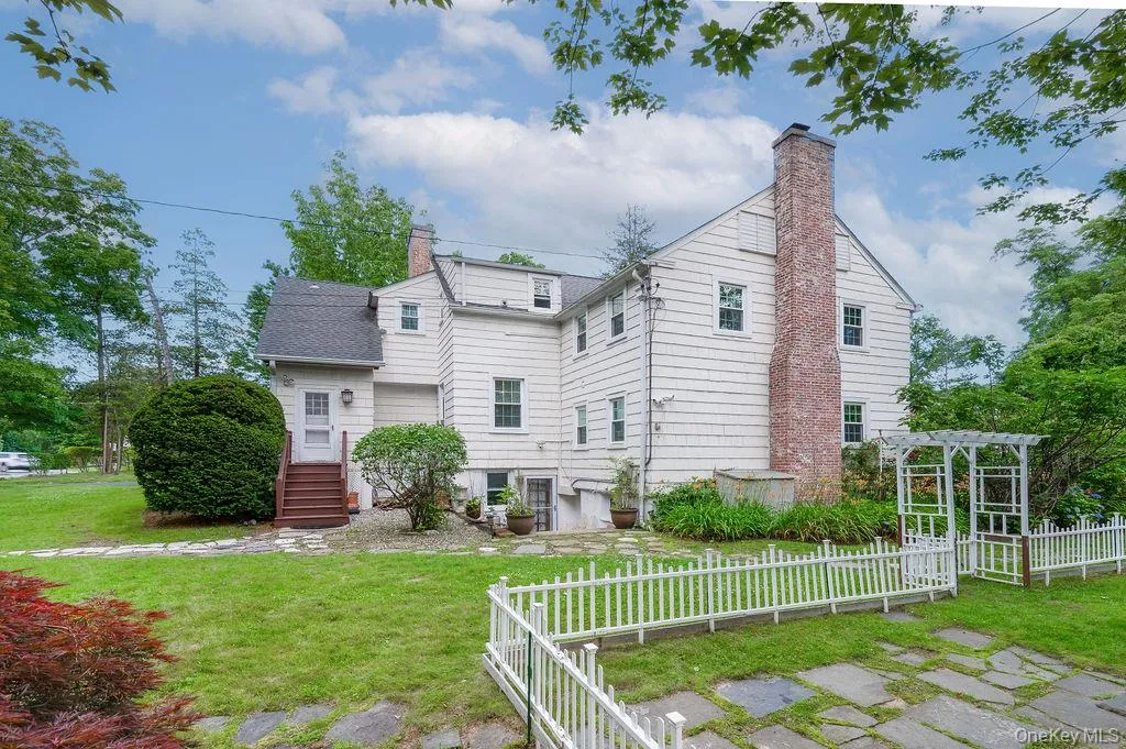 Back of house featuring a chimney Back of house featuring a chimney