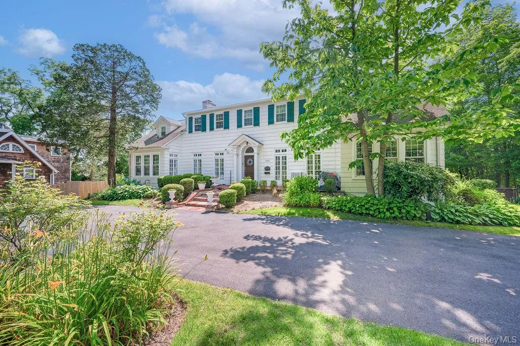 Colonial-style house with circular driveway. Colonial-style house with circular driveway.