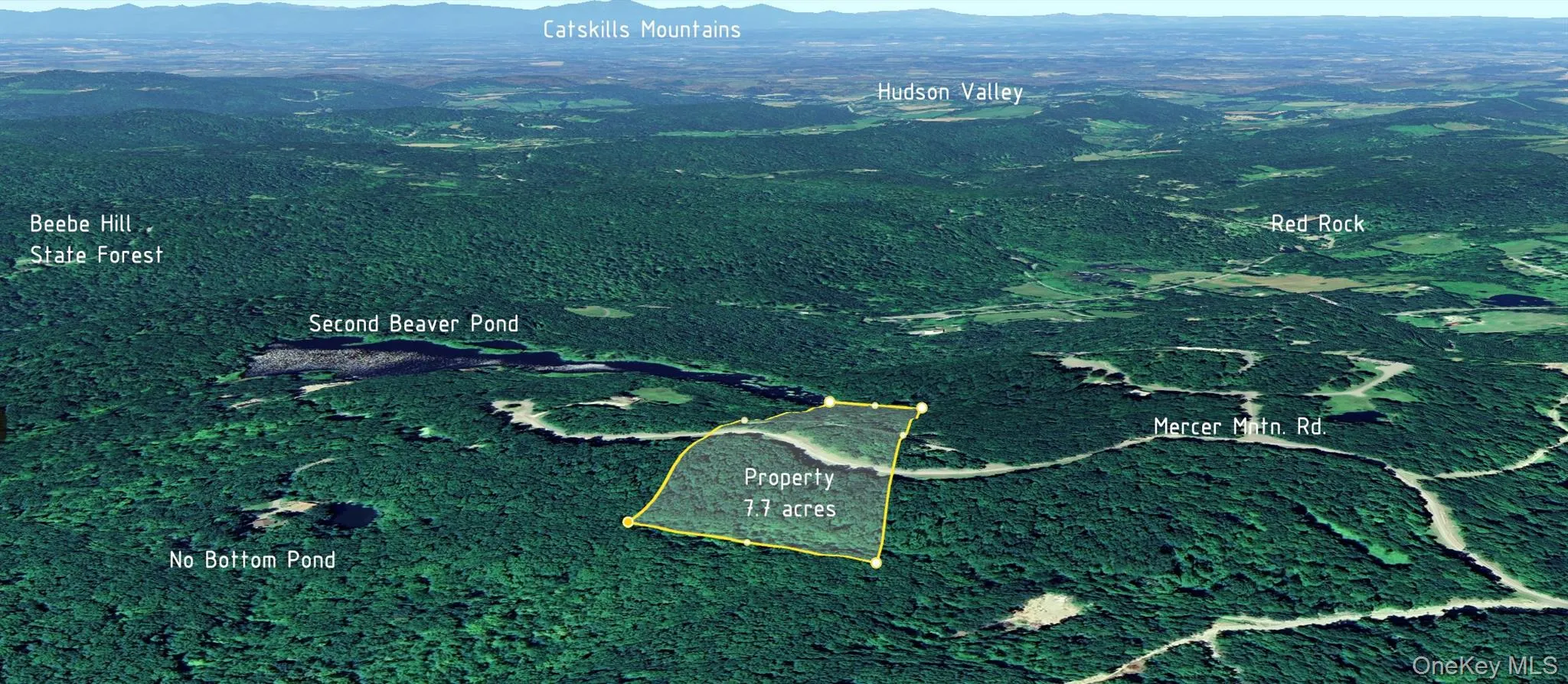Aerial view of property's location featuring a mountain backdrop and property parcel outlined Aerial view of property's location featuring a mountain backdrop and property parcel outlined