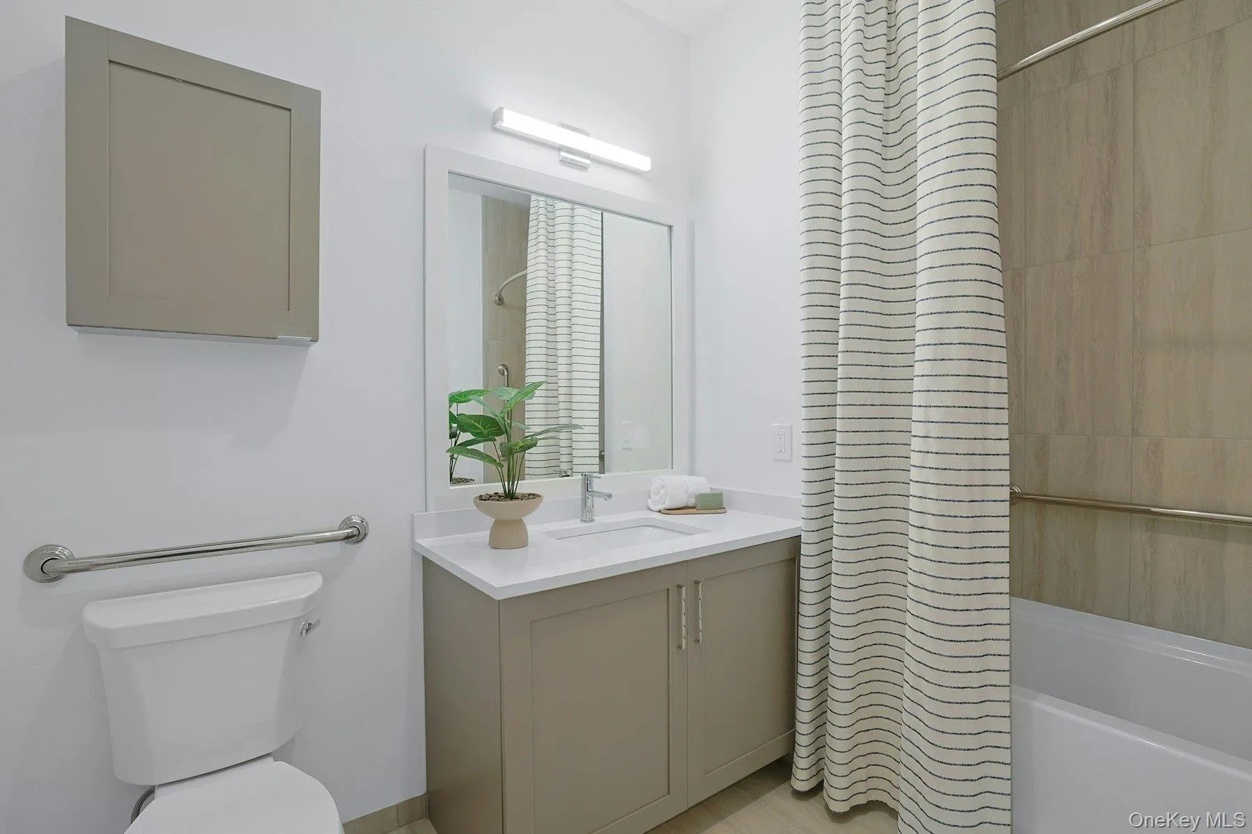 Bathroom featuring vanity and shower / tub combo Bathroom featuring vanity and shower / tub combo