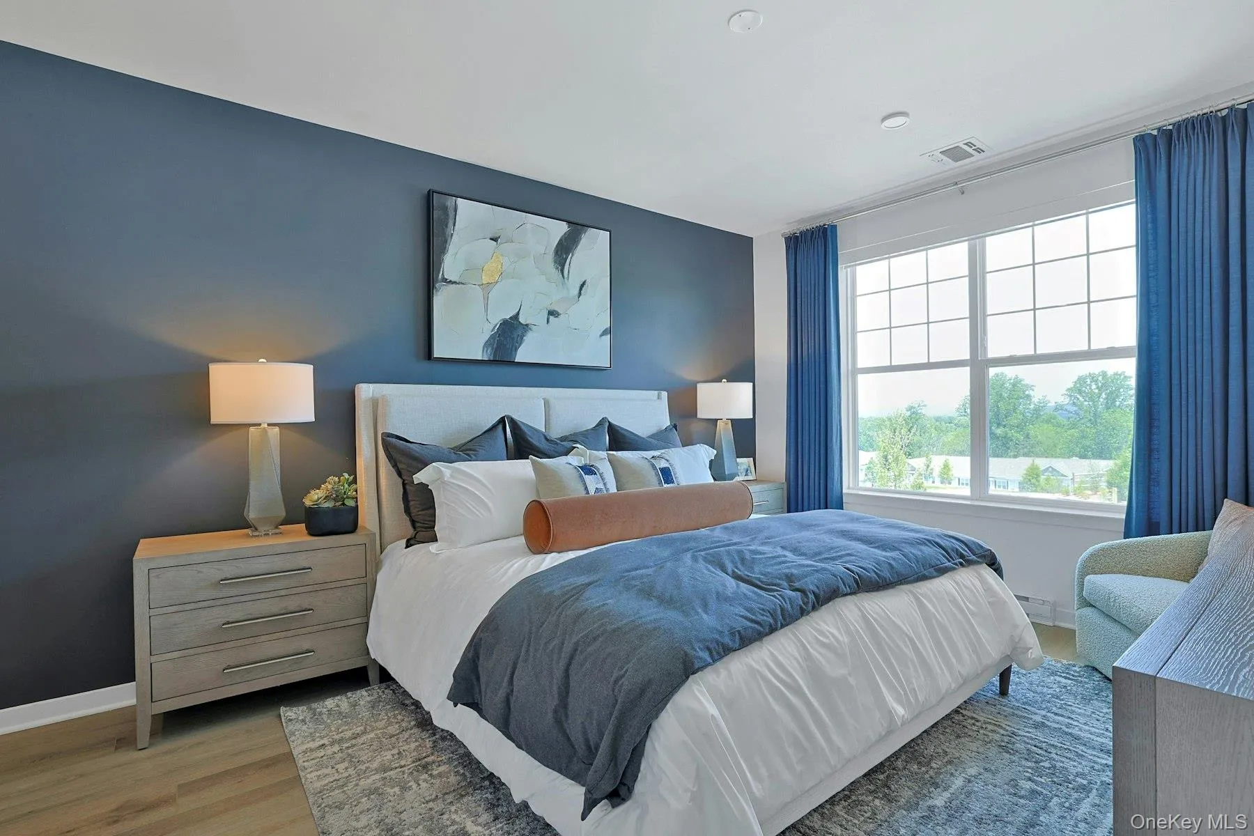 Bedroom with light wood-style flooring and baseboards Bedroom with light wood-style flooring and baseboards